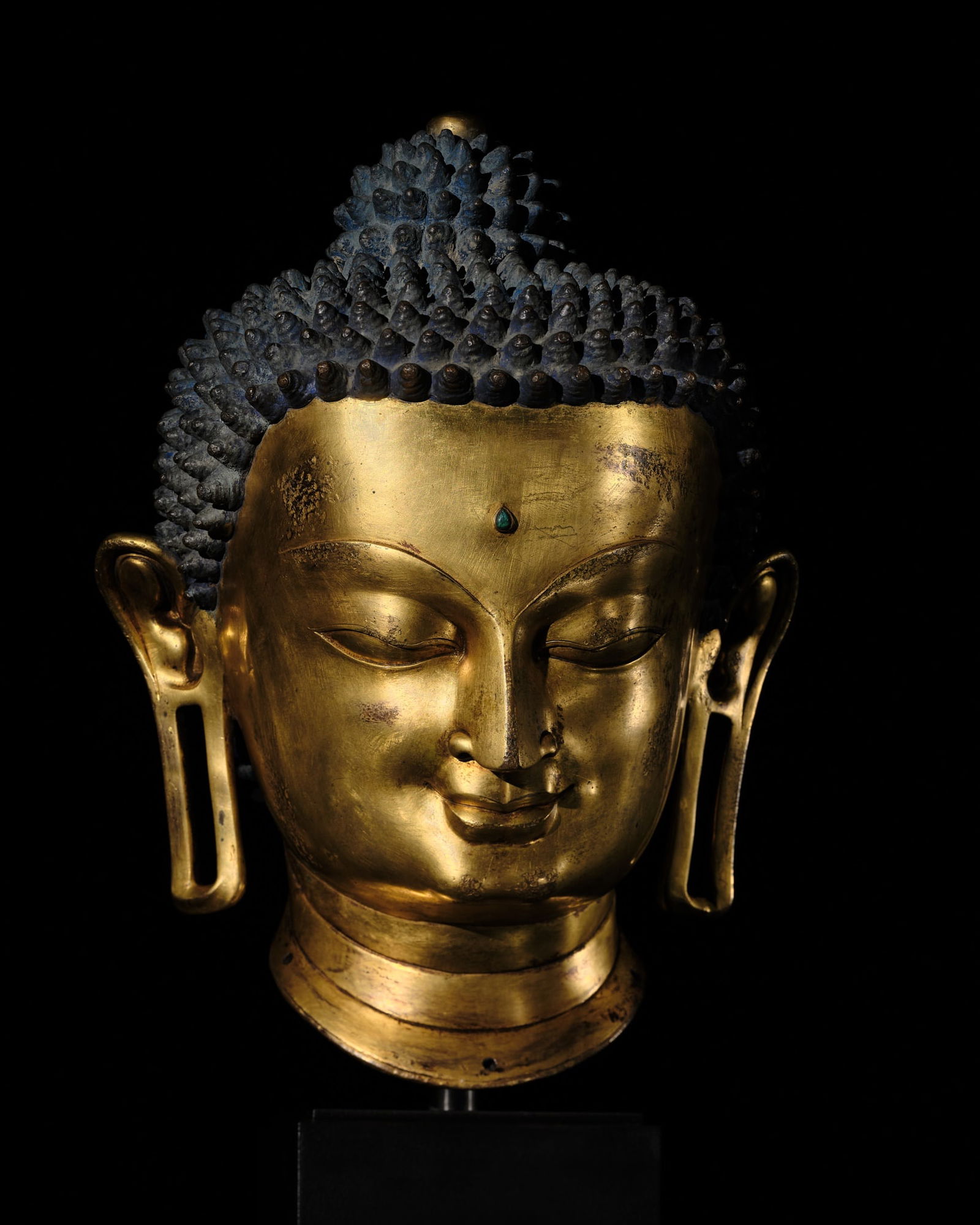 THE MONUMENTAL AND UNIQUE 'ULRICH VON SCHROEDER' GILT-COPPER HEAD OF BUDDHA, TIBET, 14TH CENTURY (1 of 20)