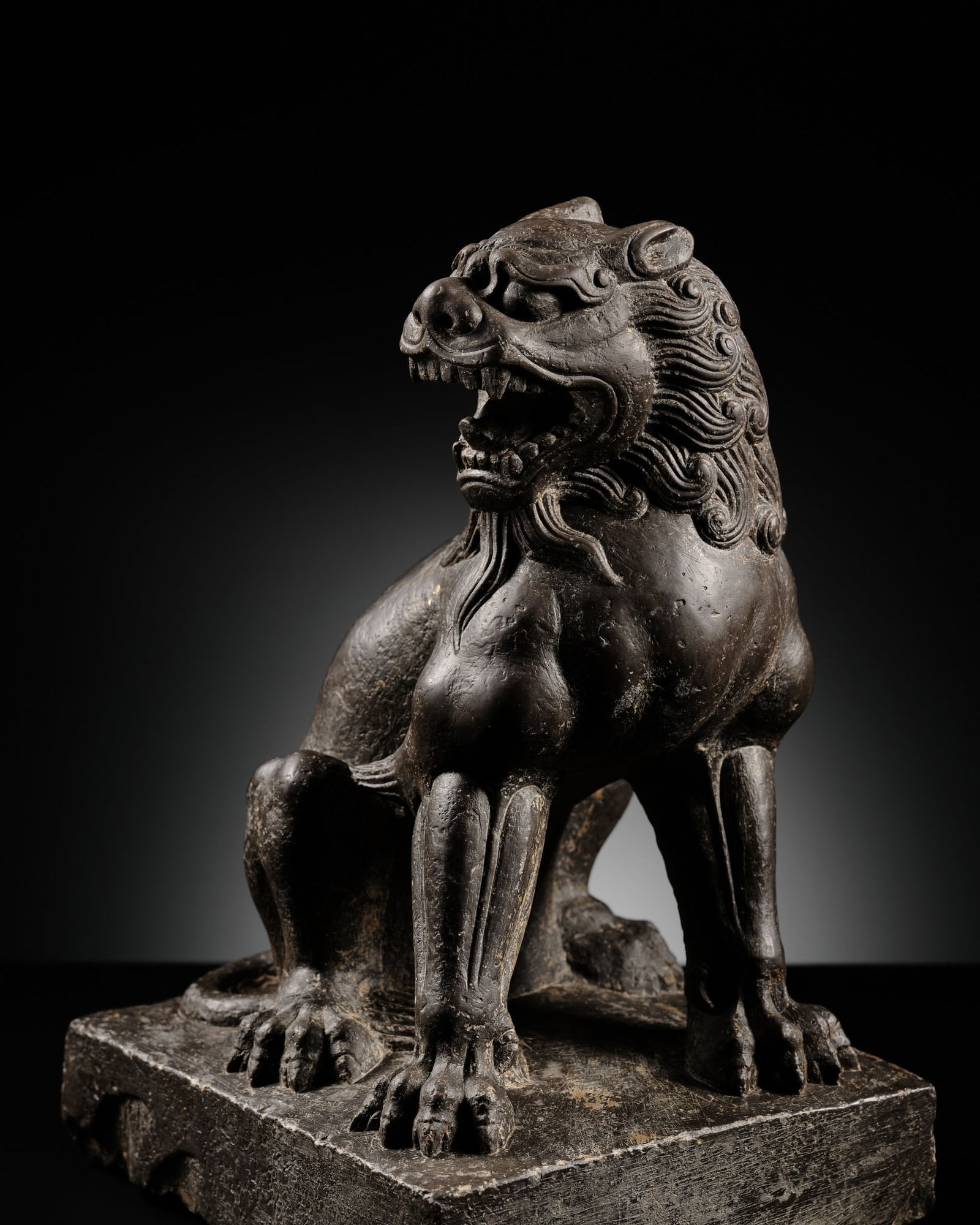 A RARE AND IMPRESSIVE BLACK STONE FIGURE OF A LION, TANG DYNASTY (1 of 16)