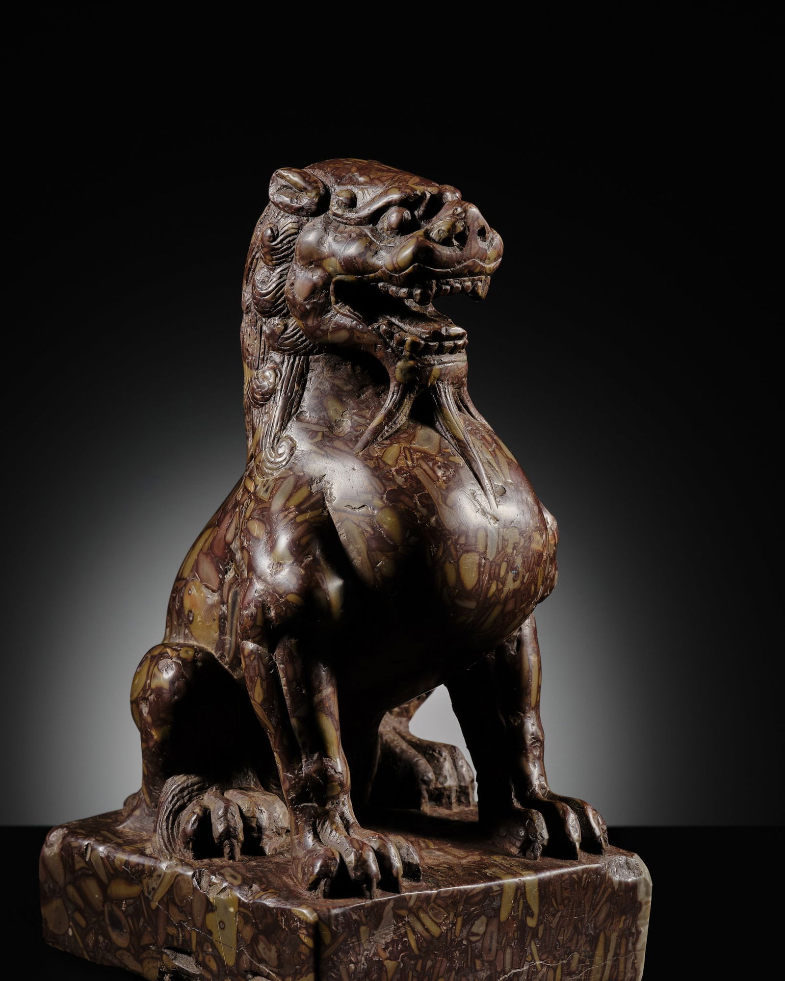 AN EXCEPTIONAL PUDDINGSTONE FIGURE OF A LION, TANG DYNASTY (1 of 18)