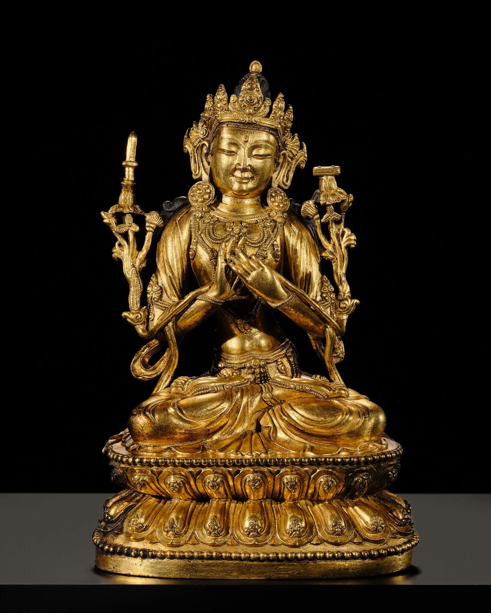 A RARE AND FINELY CAST GILT-BRONZE FIGURE OF MANJUSRI, MING DYNASTY, YONGLE TO XUANDE PERIOD: A RARE AND FINELY CAST GILT-BRONZE FIGURE OF MANJUSRI, MING DYNASTY, YONGLE TO XUANDE PERIOD (1403-1435) China. The bodhisattva is finely cast seated in dhyanasana upon a double-lotus base, the hands