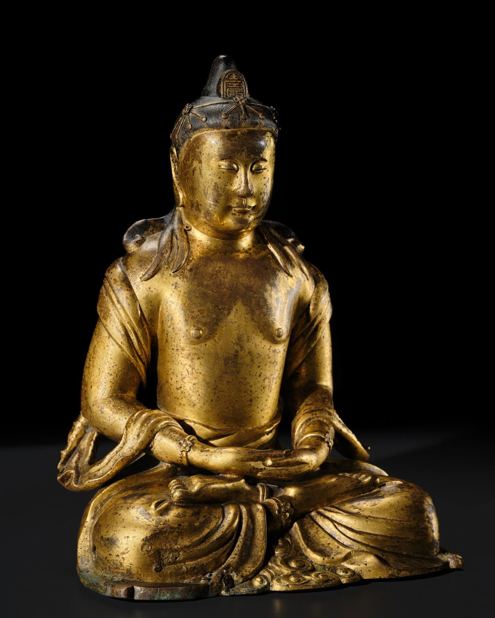 A RARE GILT COPPER ALLOY FIGURE OF AMITAYUS, MING DYNASTY: A RARE GILT COPPER ALLOY FIGURE OF AMITAYUS, MING DYNASTY Expert's note: This thickly cast and unusually restrained representation of Amitayus may explain why this figure was initially identified as K