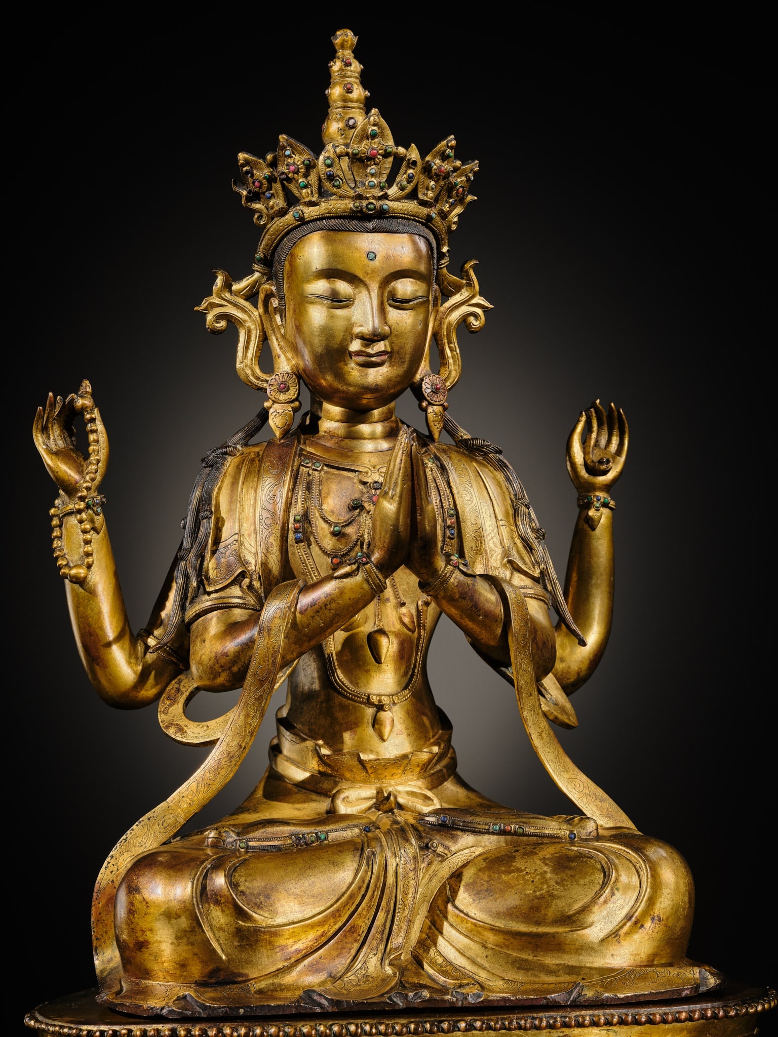 A LARGE AND FINELY INLAID SINO-TIBETAN GILT-BRONZE FIGURE OF THE FOUR-ARMED GUANYIN, SHADAKSHARI: A LARGE AND FINELY INLAID SINO-TIBETAN GILT-BRONZE FIGURE OF THE FOUR-ARMED GUANYIN, SHADAKSHARI LOKESHVARA, MING DYNASTY, 16TH TO EARLY 17TH CENTURY Expert note:Large-scale Sino-Tibetan gilt bronzes