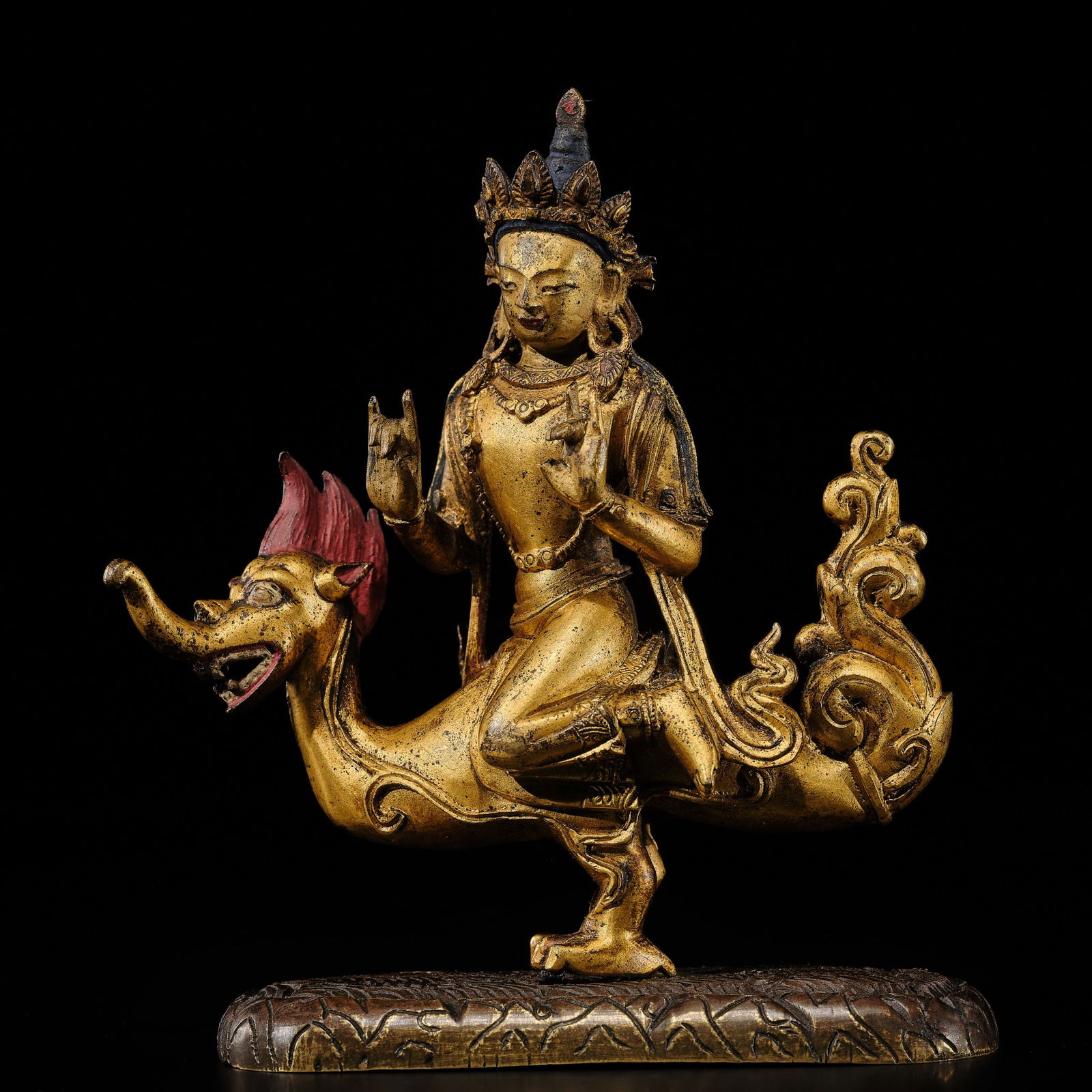 A VERY RARE GILT COPPER ALLOY FIGURE OF VARUNA, QIANLONG PERIOD: A VERY RARE GILT COPPER ALLOY FIGURE OF VARUNA, QIANLONG PERIOD China, 1736-1795. Exquisitely cast, the deity straddling a makara, the vahana well detailed with flaming red hair, long snout, open mout