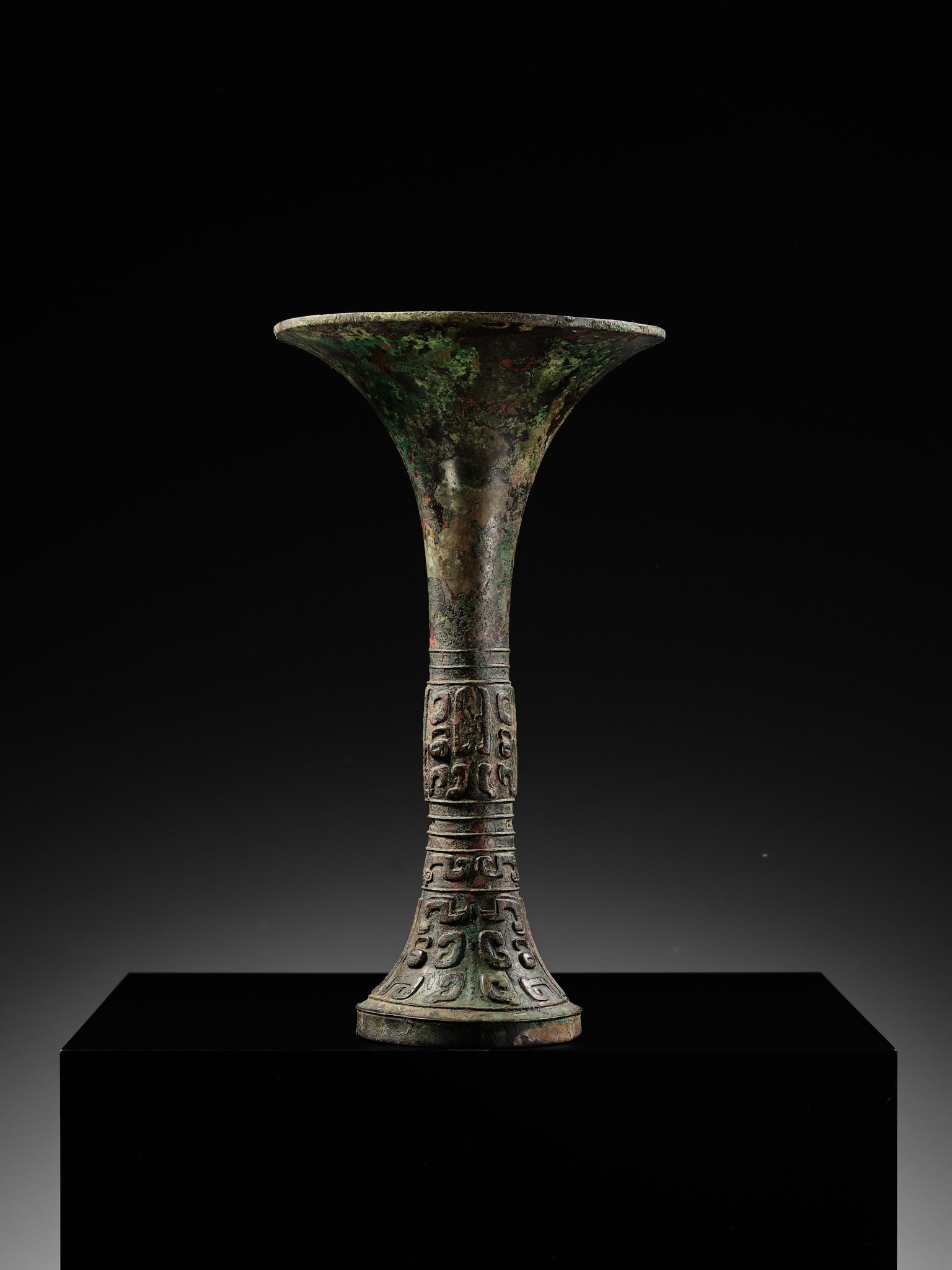 AN EXCEEDINGLY RARE BRONZE RITUAL WINE VESSEL, GU, LATE SHANG DYNASTY, ANYANG PERIOD, 12TH-11TH - 10