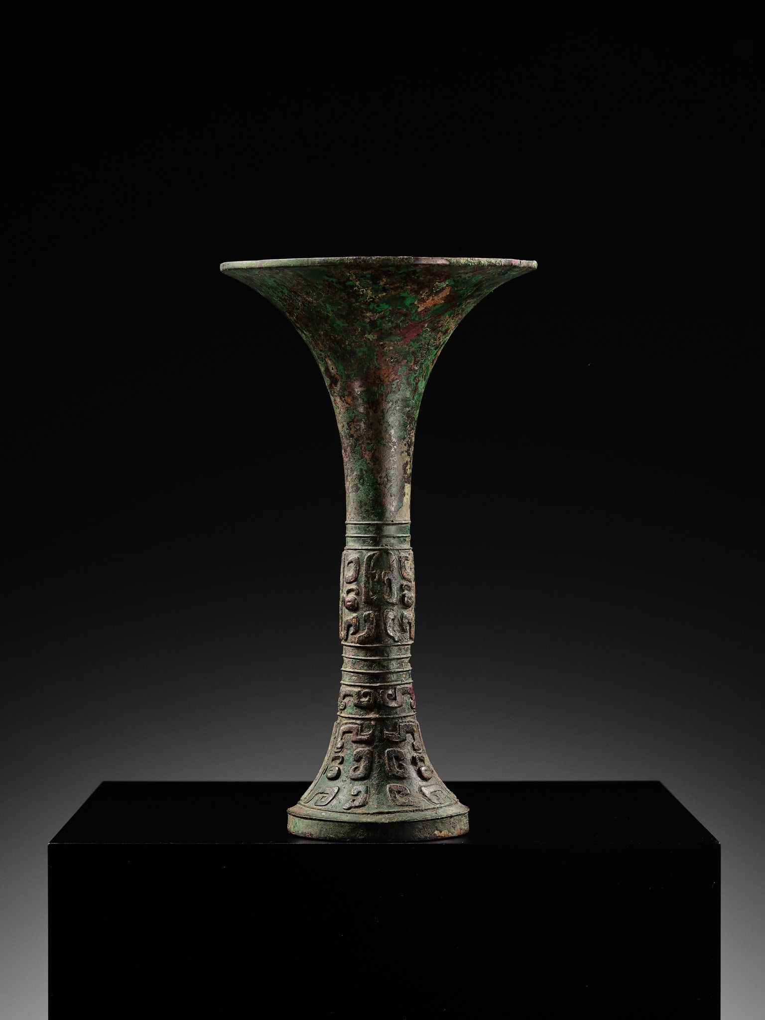 AN EXCEEDINGLY RARE BRONZE RITUAL WINE VESSEL, GU, LATE SHANG DYNASTY, ANYANG PERIOD, 12TH-11TH - 16
