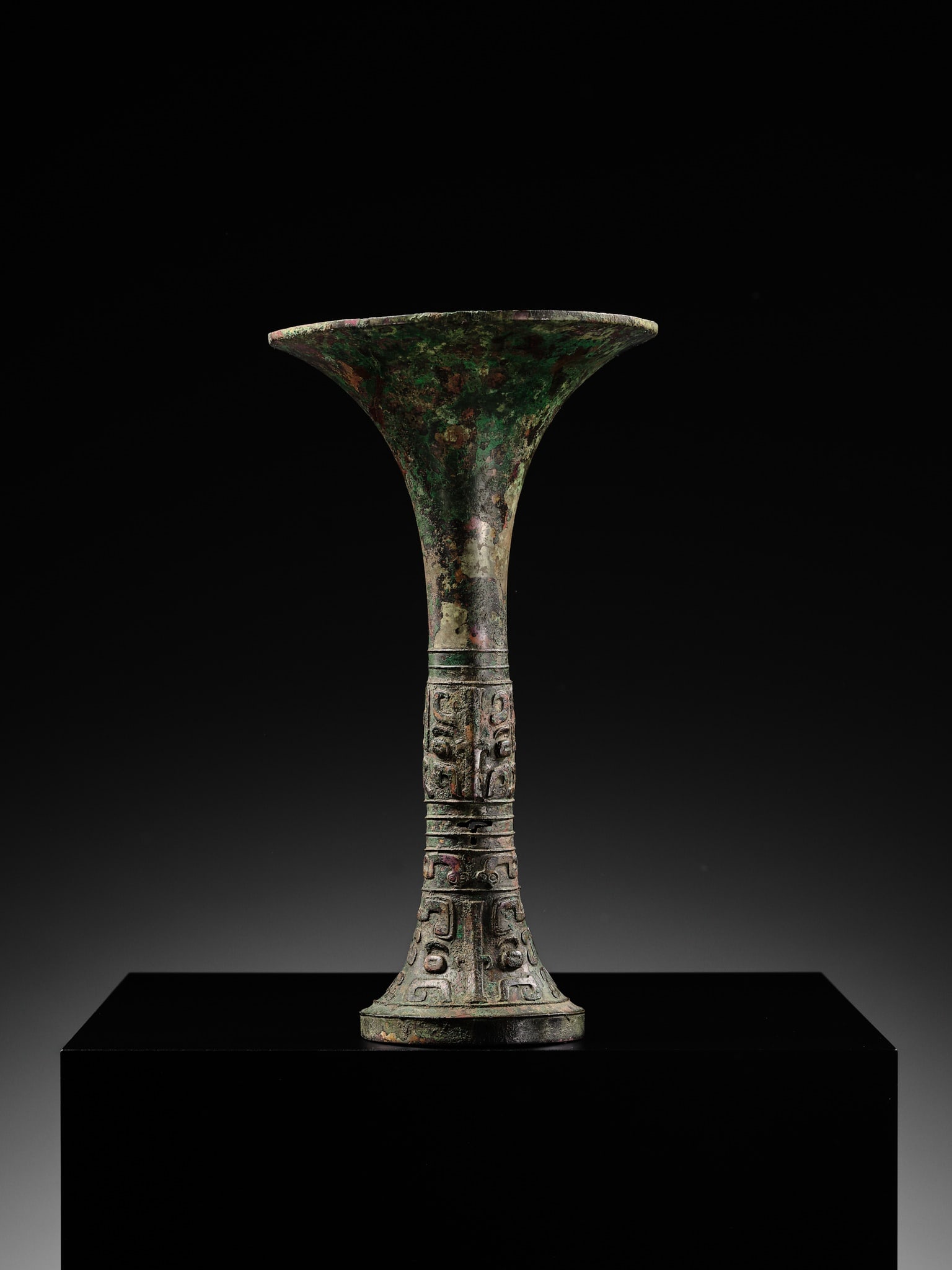 AN EXCEEDINGLY RARE BRONZE RITUAL WINE VESSEL, GU, LATE SHANG DYNASTY, ANYANG PERIOD, 12TH-11TH - 7
