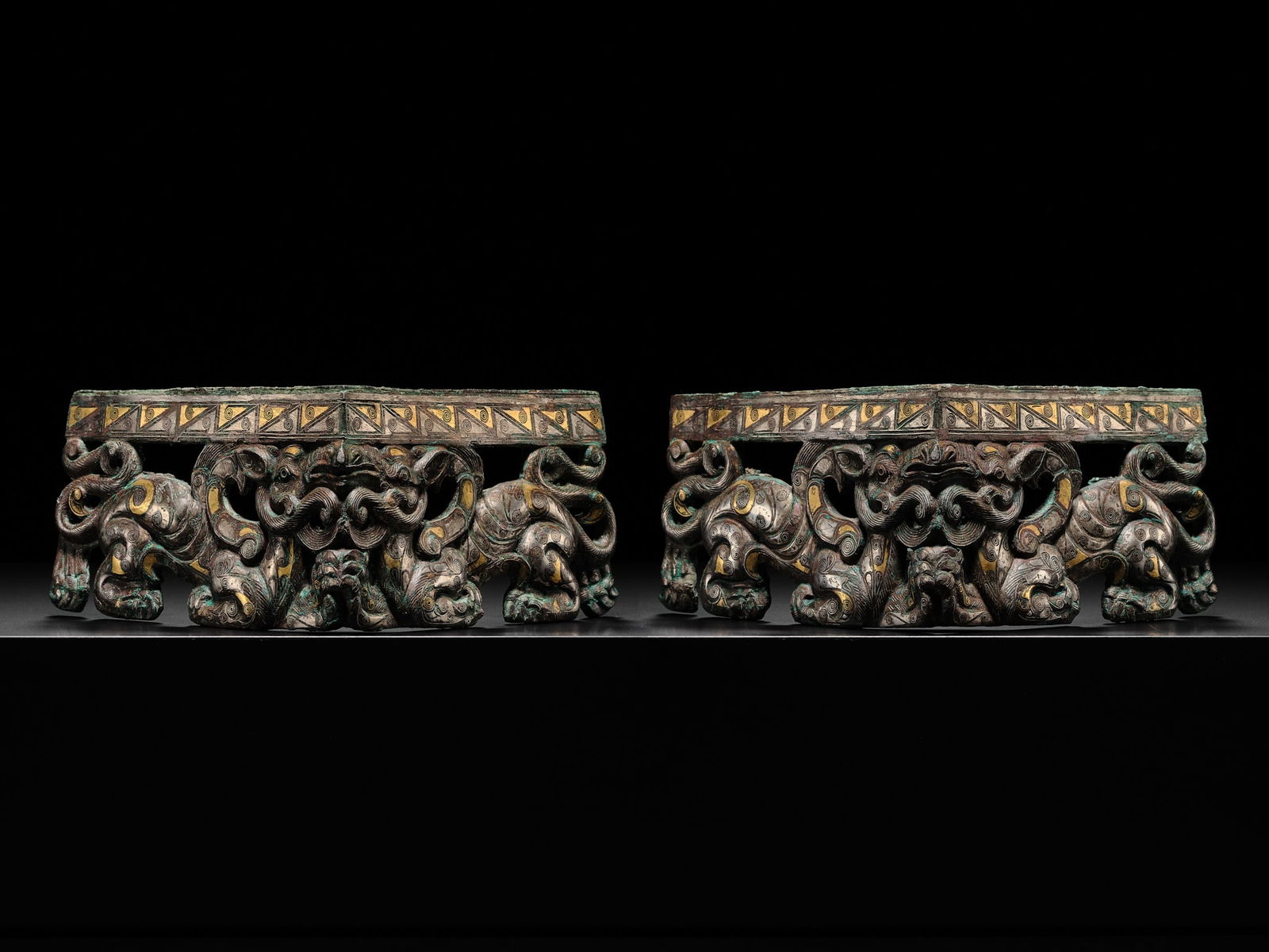 A PAIR OF RARE GOLD AND SILVER-INLAID BRONZE CORNER FITTINGS, EASTERN ZHOU DYNASTY, WARRING STATES: A PAIR OF RARE GOLD AND SILVER-INLAID BRONZE CORNER FITTINGS, EASTERN ZHOU DYNASTY, WARRING STATES PERIOD China, 475-221 BC. Superbly cast and sumptuously decorated in gold and silver inlay, the L-sha