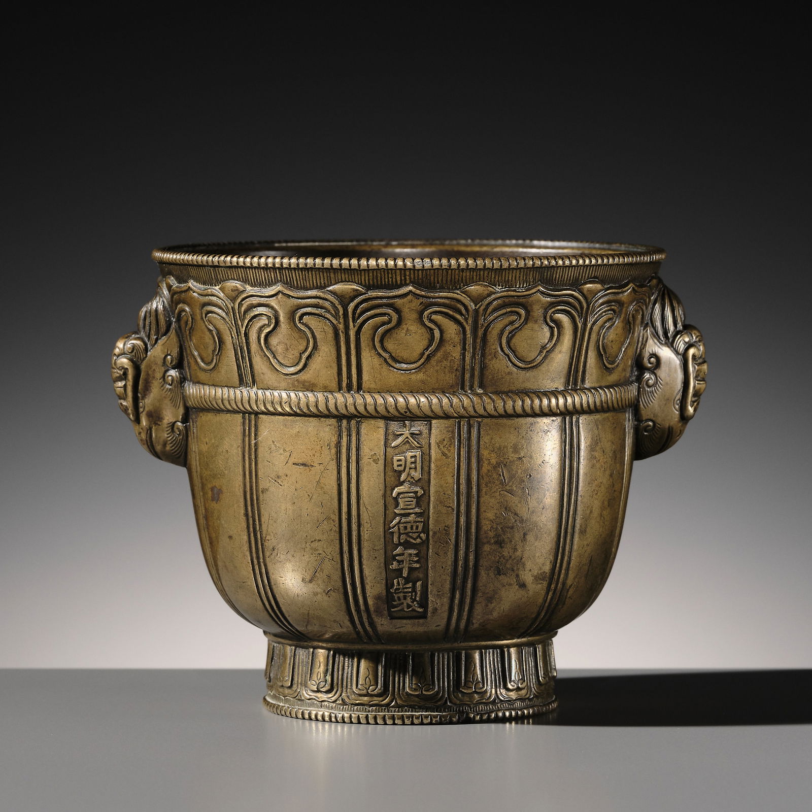 A FINE 'PHOENIX-HEAD' BRONZE CENSER, XUANDE MARK, MING DYNASTY: A FINE 'PHOENIX-HEAD' BRONZE CENSER, XUANDE MARK, MING DYNASTY China, 17th century or earlier. The deep cup-shaped body is finely cast with gently tapering sides, supported on a high, slightly splayed
