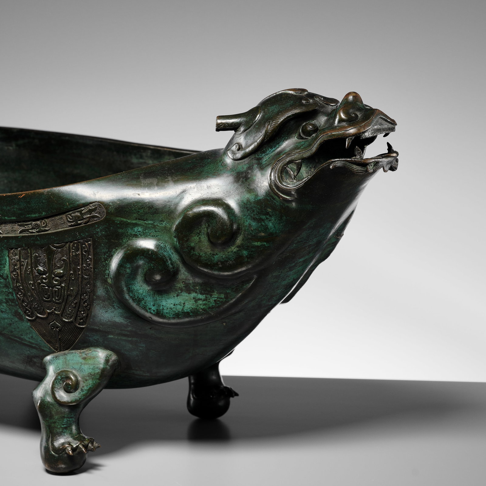 A RARE AND MASSIVE (70 CM) ARCHAISTIC BEAST-FORM VESSEL, YI, 17TH-18TH CENTURY: A RARE AND MASSIVE (70 CM) ARCHAISTIC BEAST-FORM VESSEL, YI, 17TH-18TH CENTURY Expert's note: The present archaistic vessel is remarkable for its massive size. Qing-dynasty archaistic animal-form