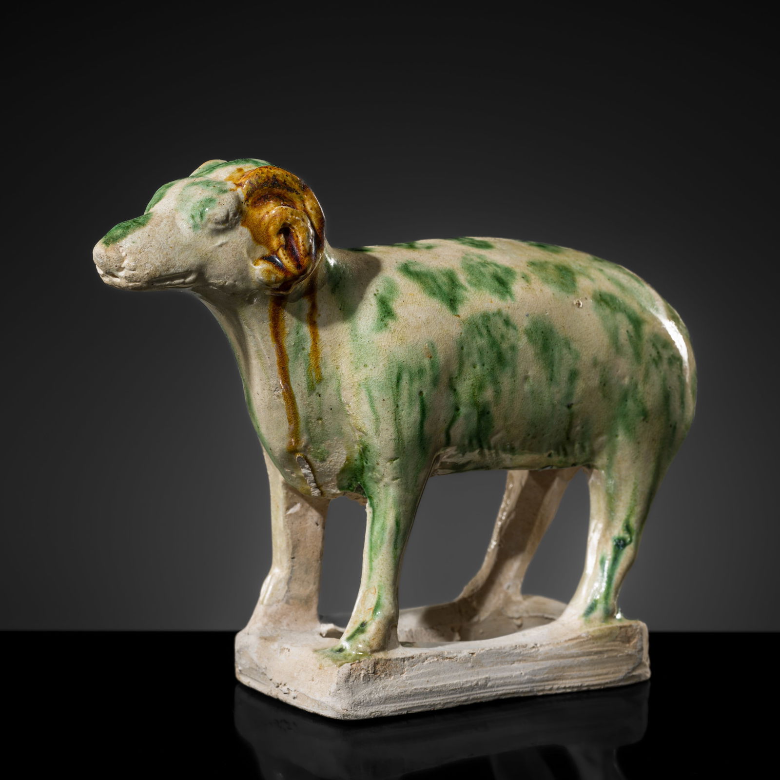 A RARE SANCAI SPLASHED POTTERY FIGURE OF A RAM, TANG DYNASTY (1 of 15)