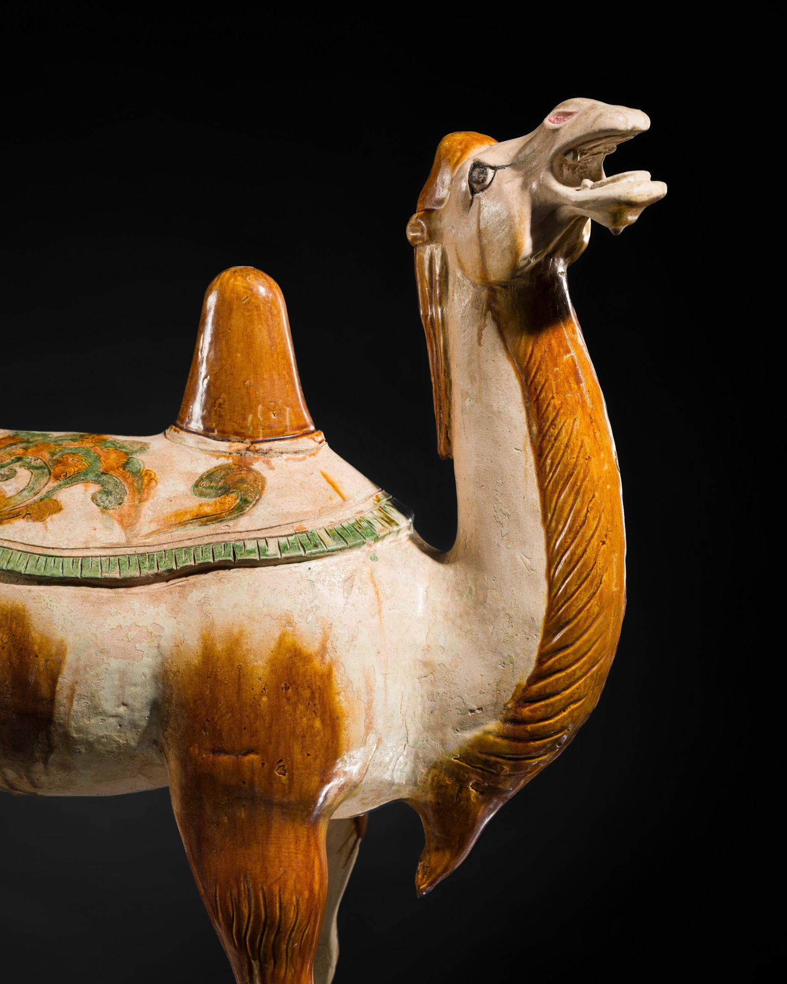 A VERY LARGE (71 CM) SANCAI-GLAZED AND INCISED POTTERY FIGURE OF A BACTRIAN CAMEL, TANG DYNASTY (1 of 16)