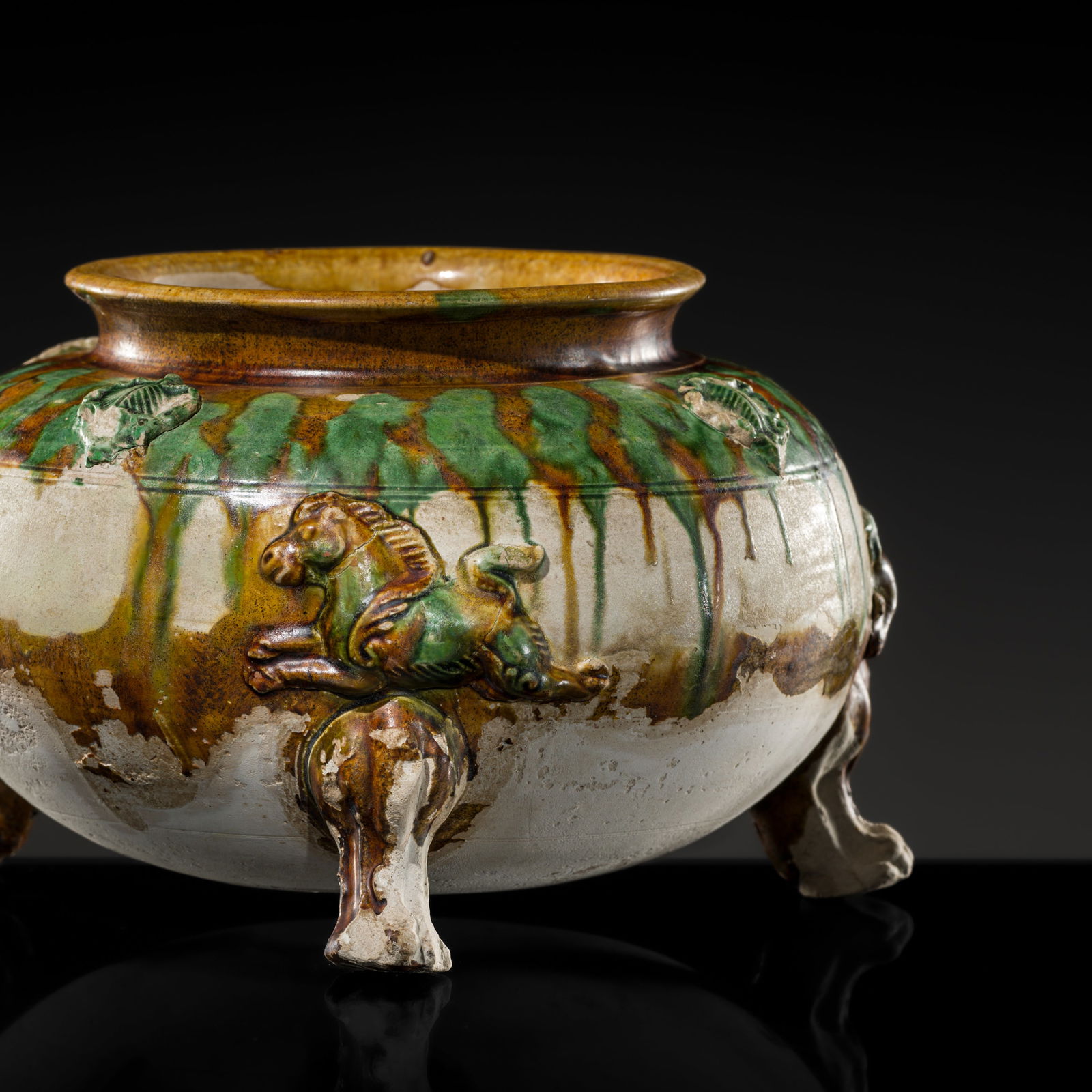 A SANCAI-GLAZED APPLIQUÉ-DECORATED TRIPOD JAR, TANG DYNASTY (1 of 17)