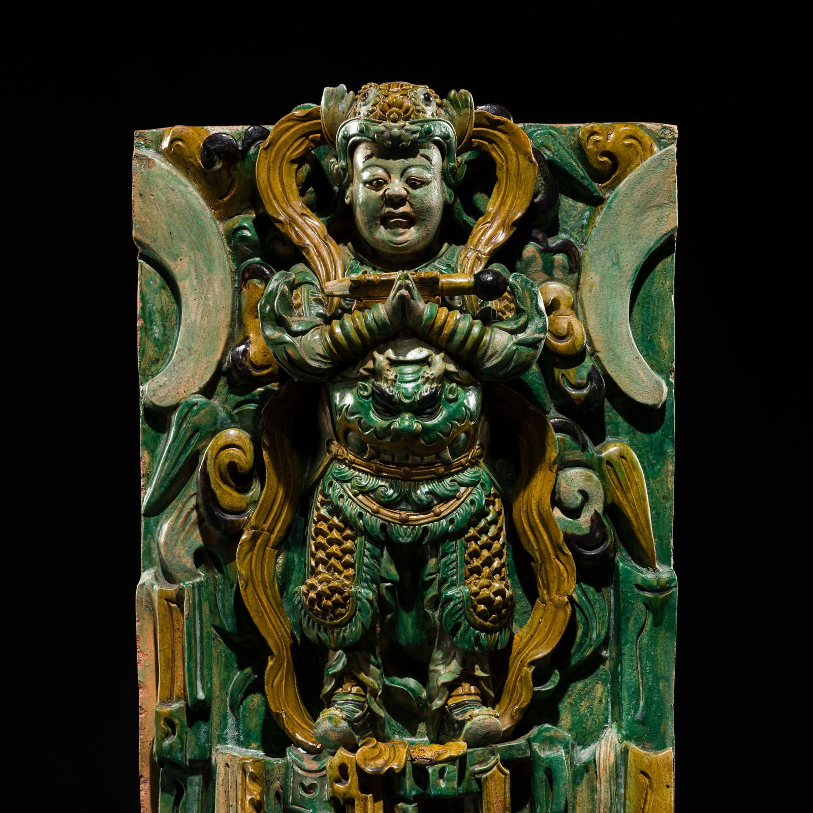 A FINELY MODELED SANCAI-GLAZED CENTERPIECE PANEL OF WEITUO, MING DYNASTY: A FINELY MODELED SANCAI-GLAZED CENTERPIECE PANEL OF WEITUO, MING DYNASTY China, 1368-1644. This architectural component, much more imposing than an ordinary tile, was designed as the main centerpiece