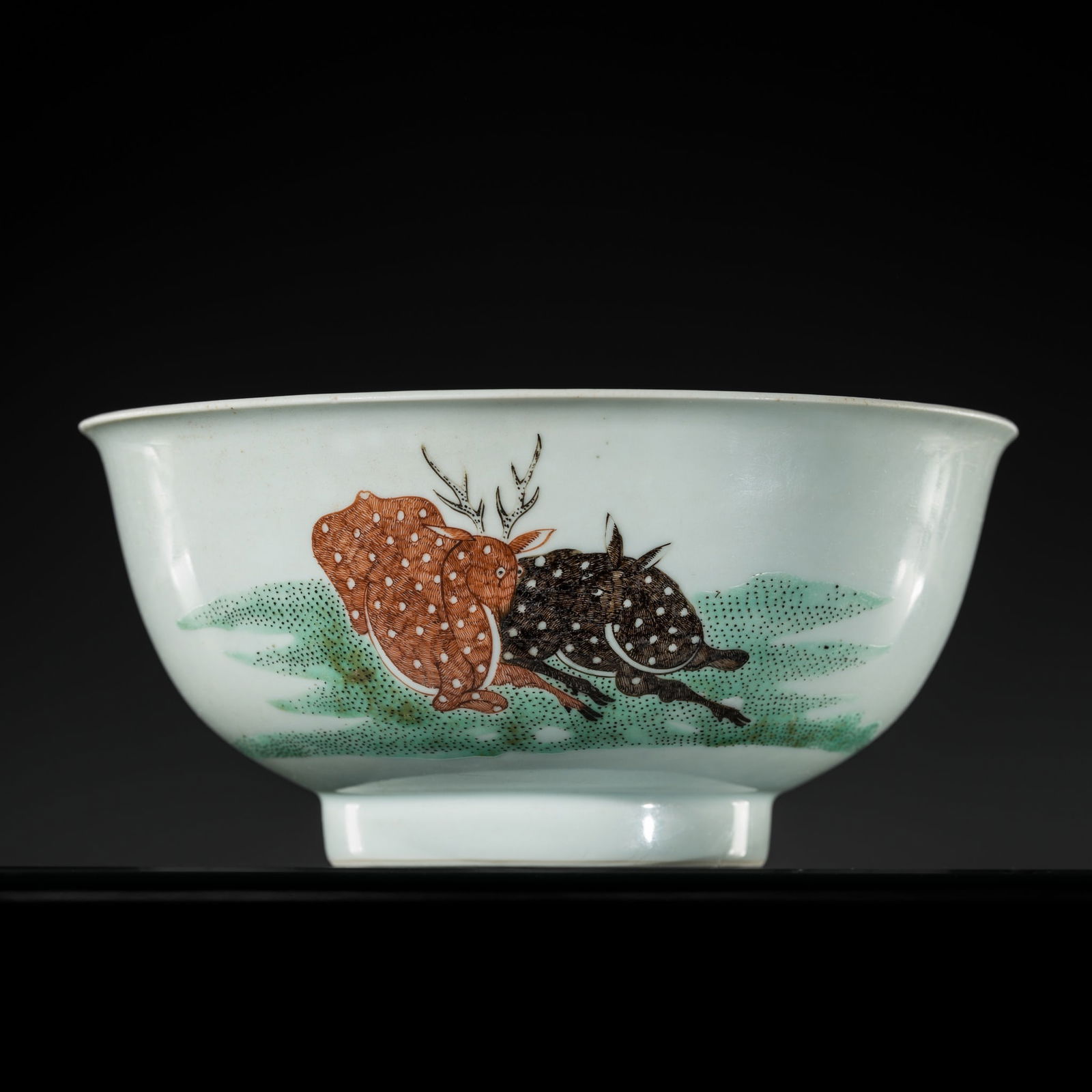 A RARE AND CHARMING 'SPOTTED DEER AND BATS' BOWL, LATE KANGXI TO YONGZHENG PERIOD: A RARE AND CHARMING 'SPOTTED DEER AND BATS' BOWL, LATE KANGXI TO YONGZHENG PERIOD Expert's note: The green enamel ground on which the deer are set recalls techniques developed during the Kangxi period