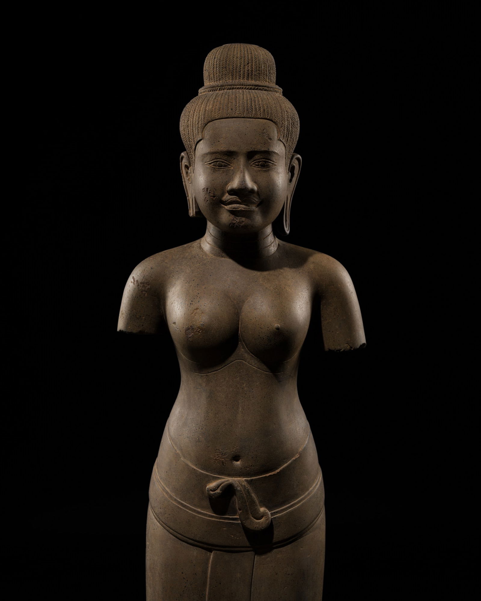 A HIGHLY IMPORTANT SANDSTONE FIGURE OF UMA, ANGKOR PERIOD, BAPHUON STYLE, EARLY 11TH CENTURY: A HIGHLY IMPORTANT SANDSTONE FIGURE OF UMA, ANGKOR PERIOD, BAPHUON STYLE, EARLY 11TH CENTURY Expert's note: This exceptional sculpture is most remarkable for the tactile quality of its polished surfac