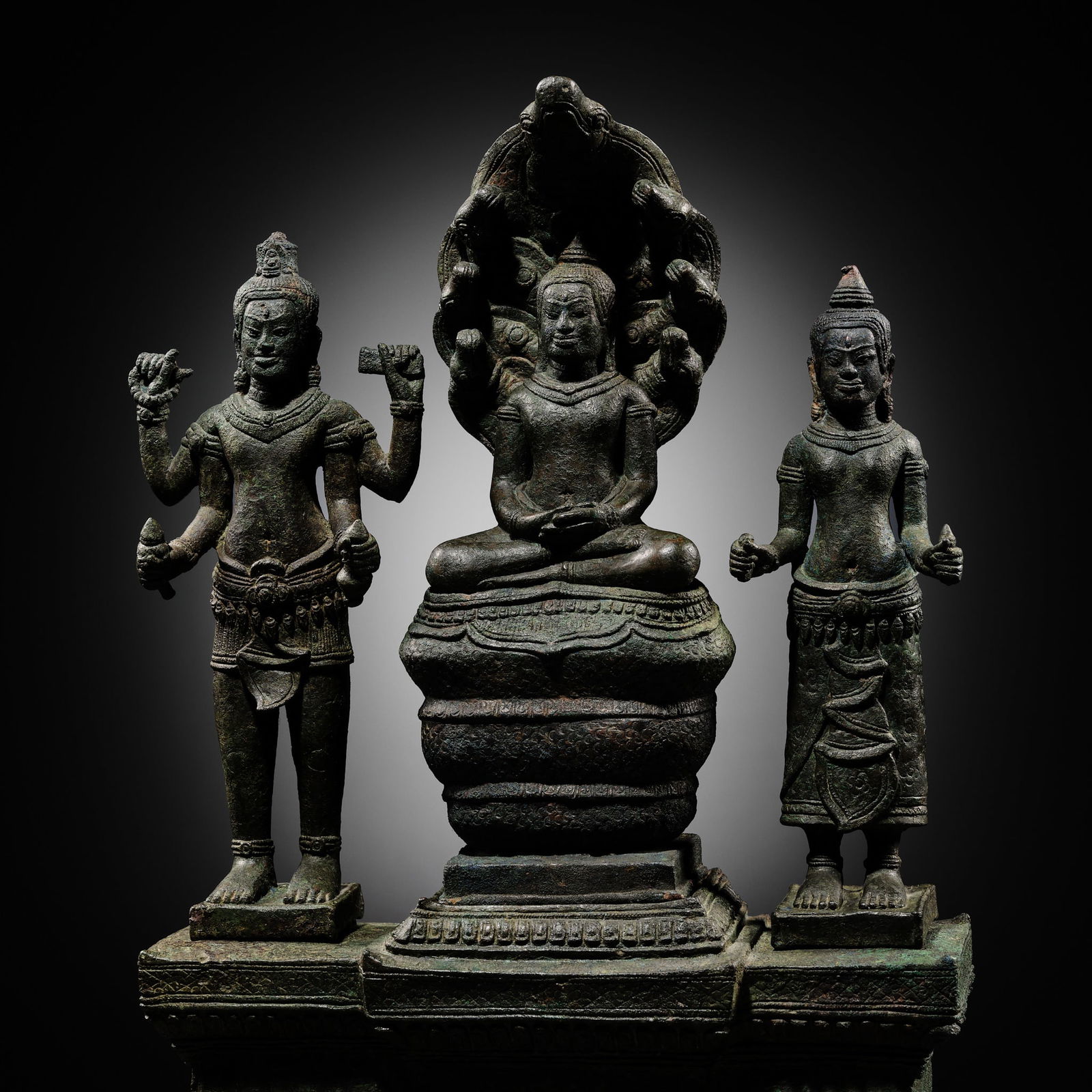 A BUDDHIST BRONZE TRIAD OF BUDDHA MUCHALINDA WITH HIS CONSORTS LOKESHVARA AND PRAJNAPARAMITA, BAYON (1 of 16)