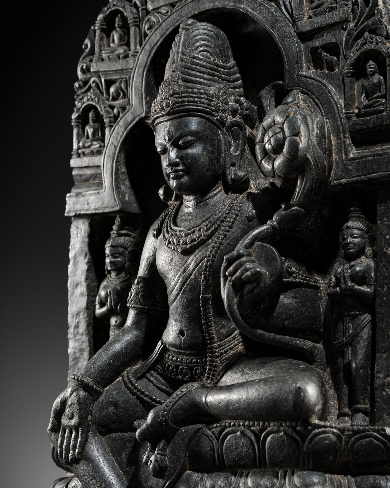 AN IMPORTANT BLACK STONE STELE OF PADMAPANI, PALA PERIOD, NORTHEASTERN INDIA, 10TH-12TH CENTURY: AN IMPORTANT BLACK STONE STELE OF PADMAPANI, PALA PERIOD, NORTHEASTERN INDIA, 10TH-12TH CENTURY Padmapani, the lotus bearer, is seated in lalitasana on a double lotus throne with a pendent leg resting
