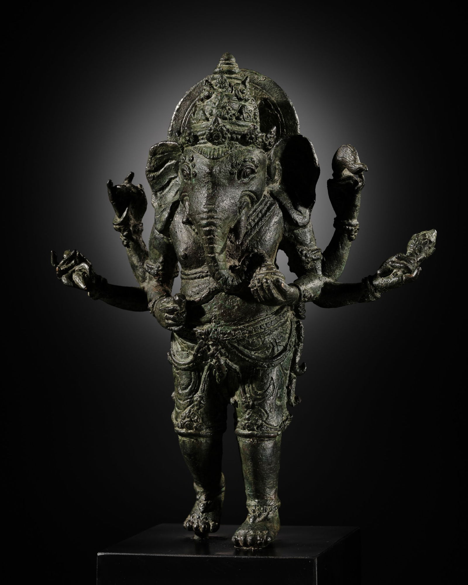 A BRONZE FIGURE OF GANESHA, SOUTHEAST ASIA, CHOLA EMPIRE SPHERE, 12TH-13TH CENTURY: A BRONZE FIGURE OF GANESHA, SOUTHEAST ASIA, CHOLA EMPIRE SPHERE, 12TH-13TH CENTURY Expert's note:The Chola Empire was a medieval thalassocrat power based in southern India, ruled by the Chola dynasty,