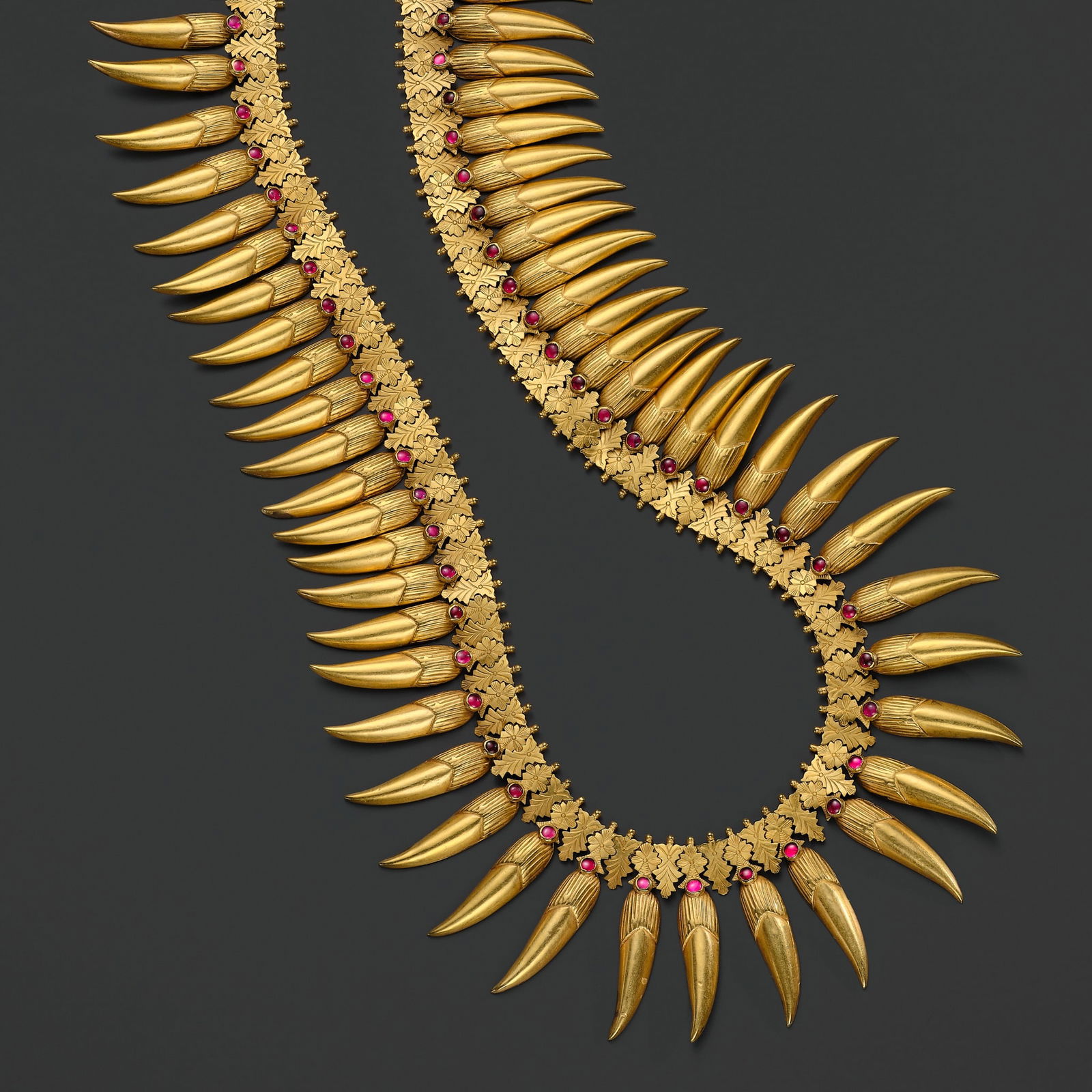 A RUBY-INSET 18 CARAT GOLD (292 GRAMS) 'JASMINE BUD' BRIDAL NECKLACE, MALLIGAI ARUMBU MALAI, TAMIL: A RUBY-INSET 18 CARAT GOLD (292 GRAMS) 'JASMINE BUD' BRIDAL NECKLACE, MALLIGAI ARUMBU MALAI, TAMIL NADU, 19TH CENTURY South India. Superbly modeled as 61 individual stylized buds of Arabian jasmine (J