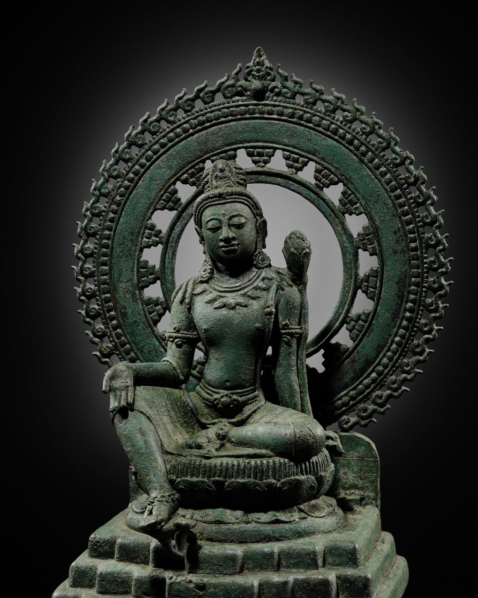A BRONZE FIGURE OF AVALOKITESHVARA PADMAPANI SEATED ON MOUNT POTALA, SRIVIJAYA EMPIRE, SUMATRA, (1 of 20)