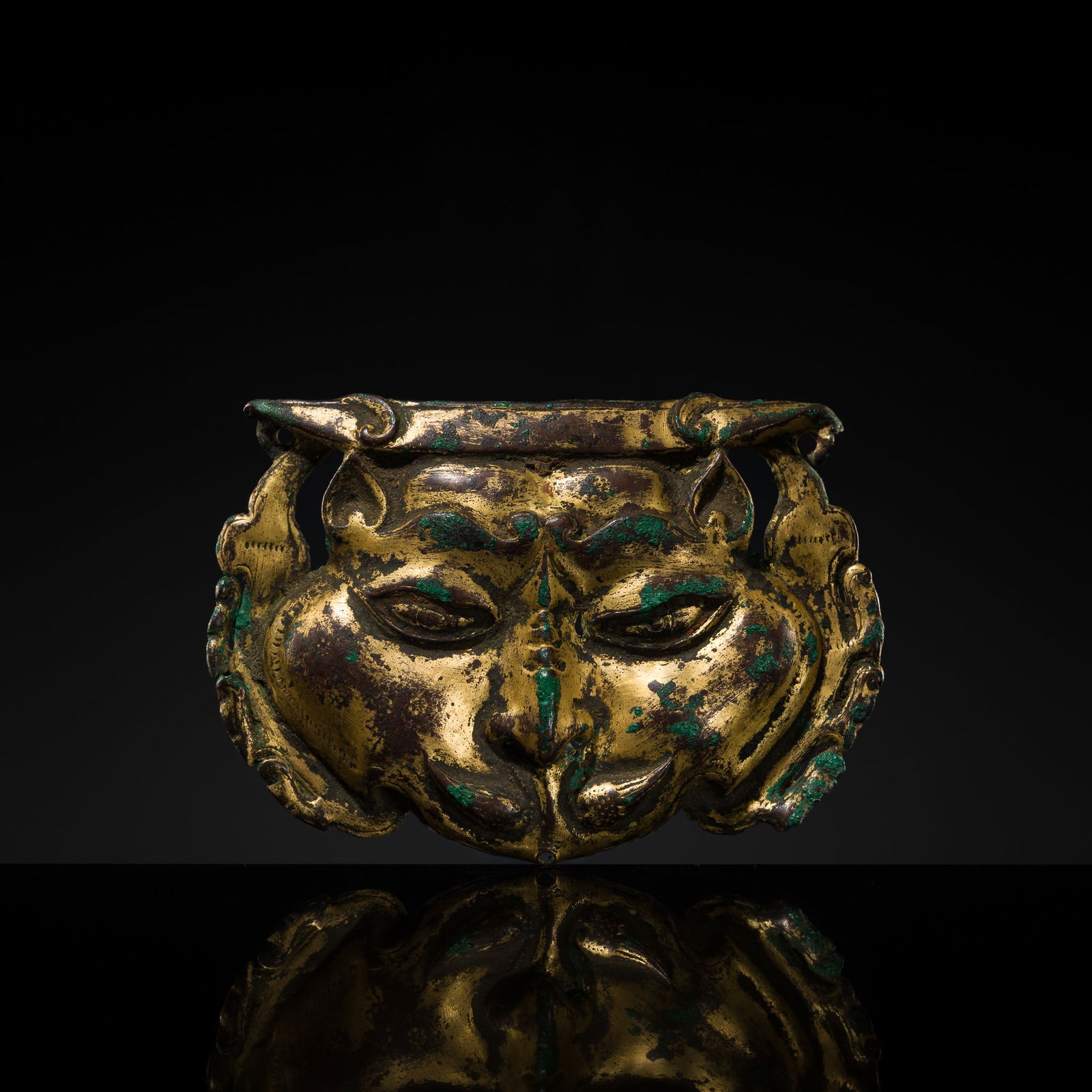 A GILT-COPPER REPOUSSÉ SNOW LION MASK, TIBET, 17TH-18TH CENTURY: A GILT-COPPER REPOUSSÉ SNOW LION MASK, TIBET, 17TH-18TH CENTURY Expert's note: The present mask displays superb fire gilding, the original mercury-gilded surface still preserved across much of th
