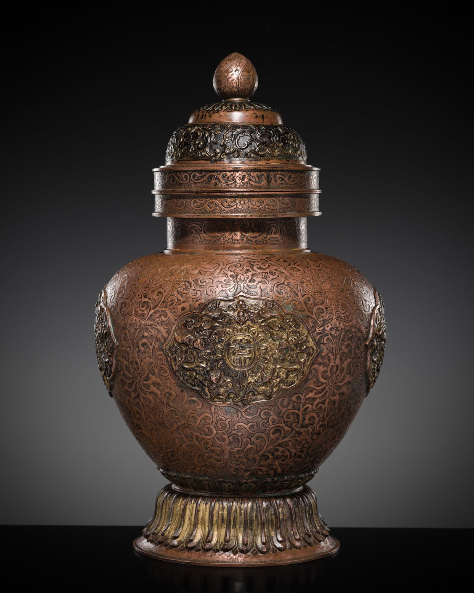 A TIBETAN-CHINESE PARCEL-GILT COPPER REPOUSSÉ JAR AND COVER, 19TH CENTURY (1 of 14)