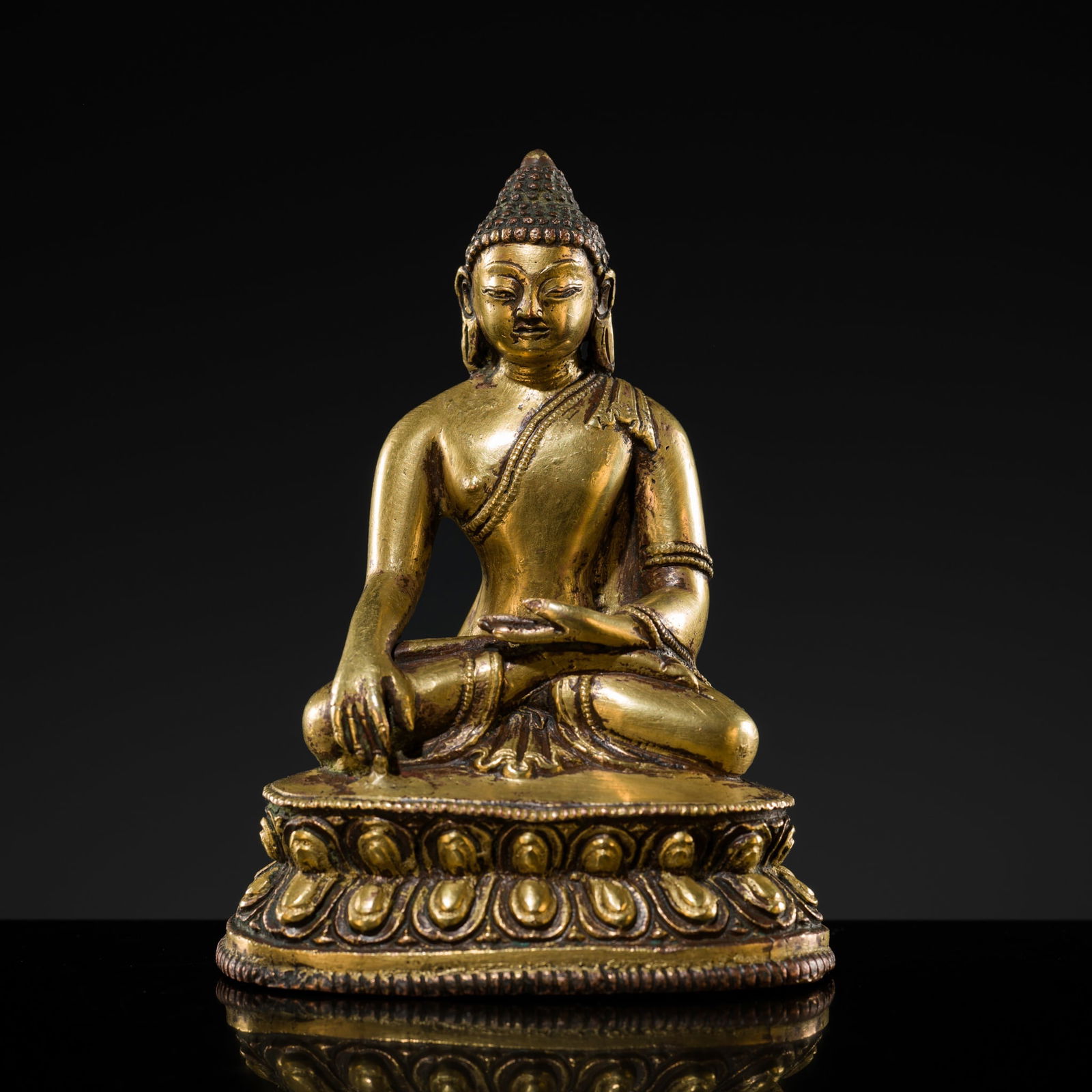 A GILT-BRONZE FIGURE OF BUDDHA SHAKYAMUNI, TIBET, 13TH-14TH CENTURY (1 of 13)