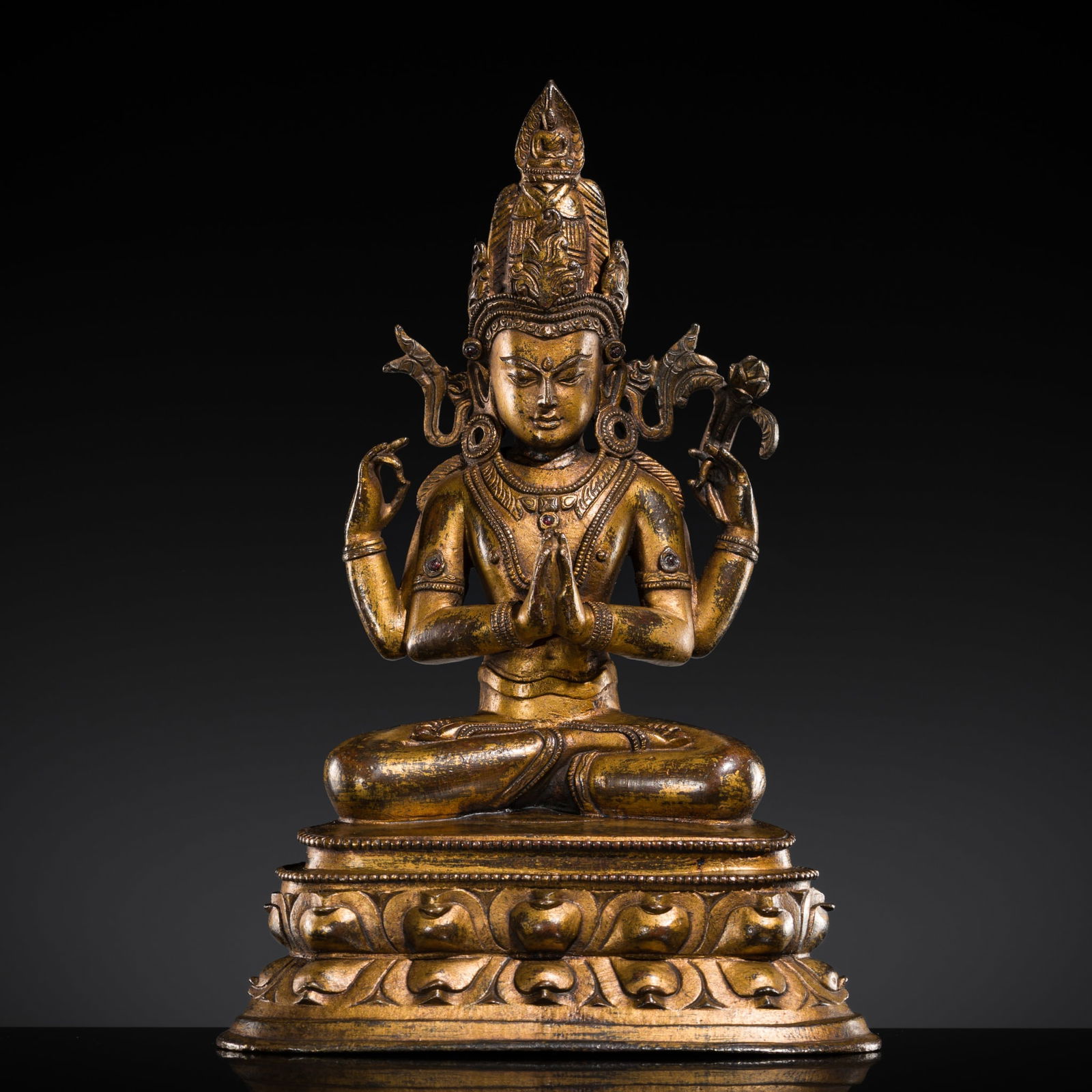 A RUBY-INLAID GILT-BRONZE FIGURE OF SHADAKSHARI LOKESHVARA, WESTERN TIBET, 14TH CENTURY (1 of 11)