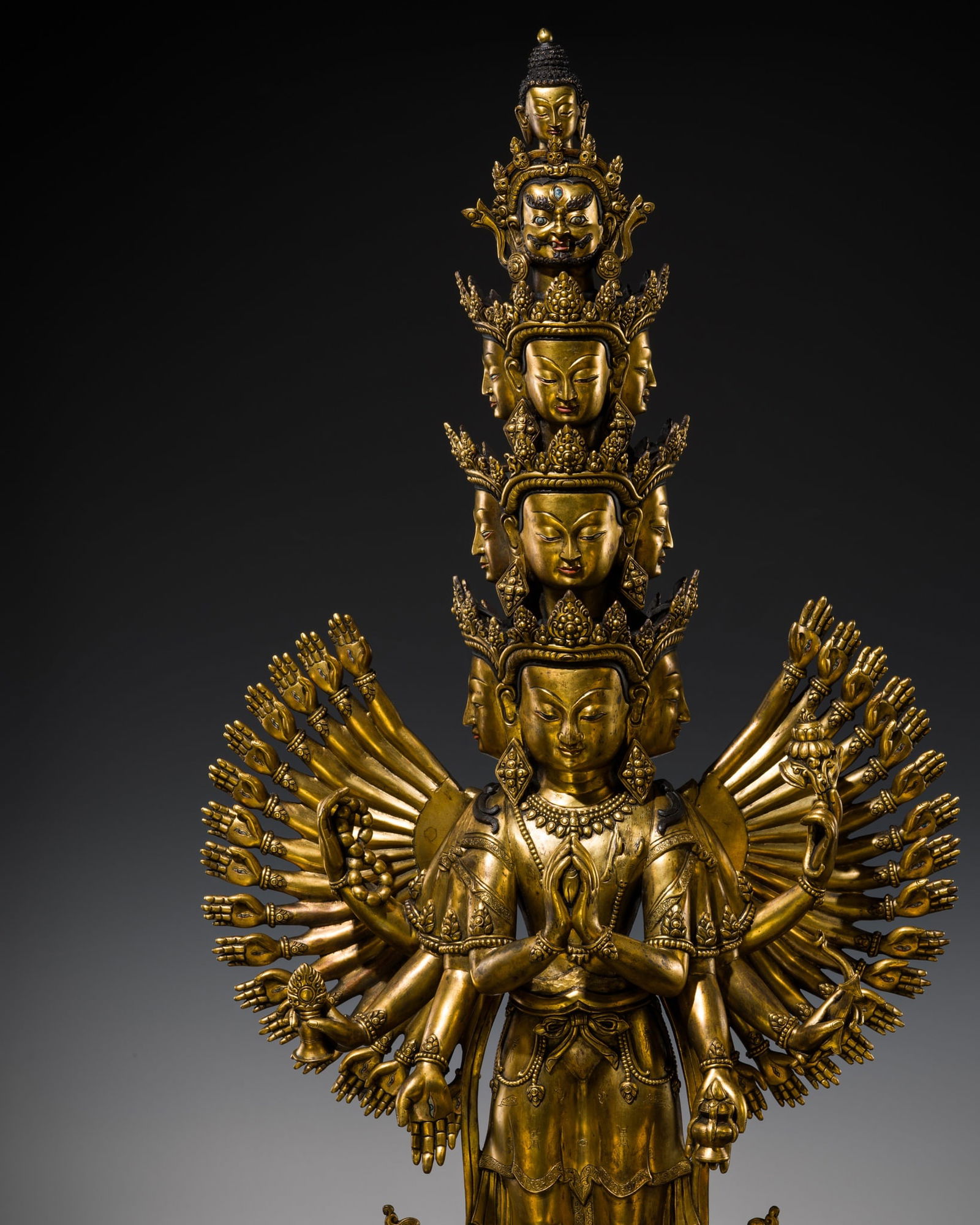 A VERY LARGE GILT COPPER ALLOY FIGURE OF AVALOKITESHVARA SAHASHRABHUJA EKADASHAMUKHA,: A VERY LARGE GILT COPPER ALLOY FIGURE OF AVALOKITESHVARA SAHASHRABHUJA EKADASHAMUKHA, TIBETAN-CHINESE, SECOND HALF OF THE 20TH CENTURY Separately cast, Avalokiteshvara stands in samabhanga on a beaded