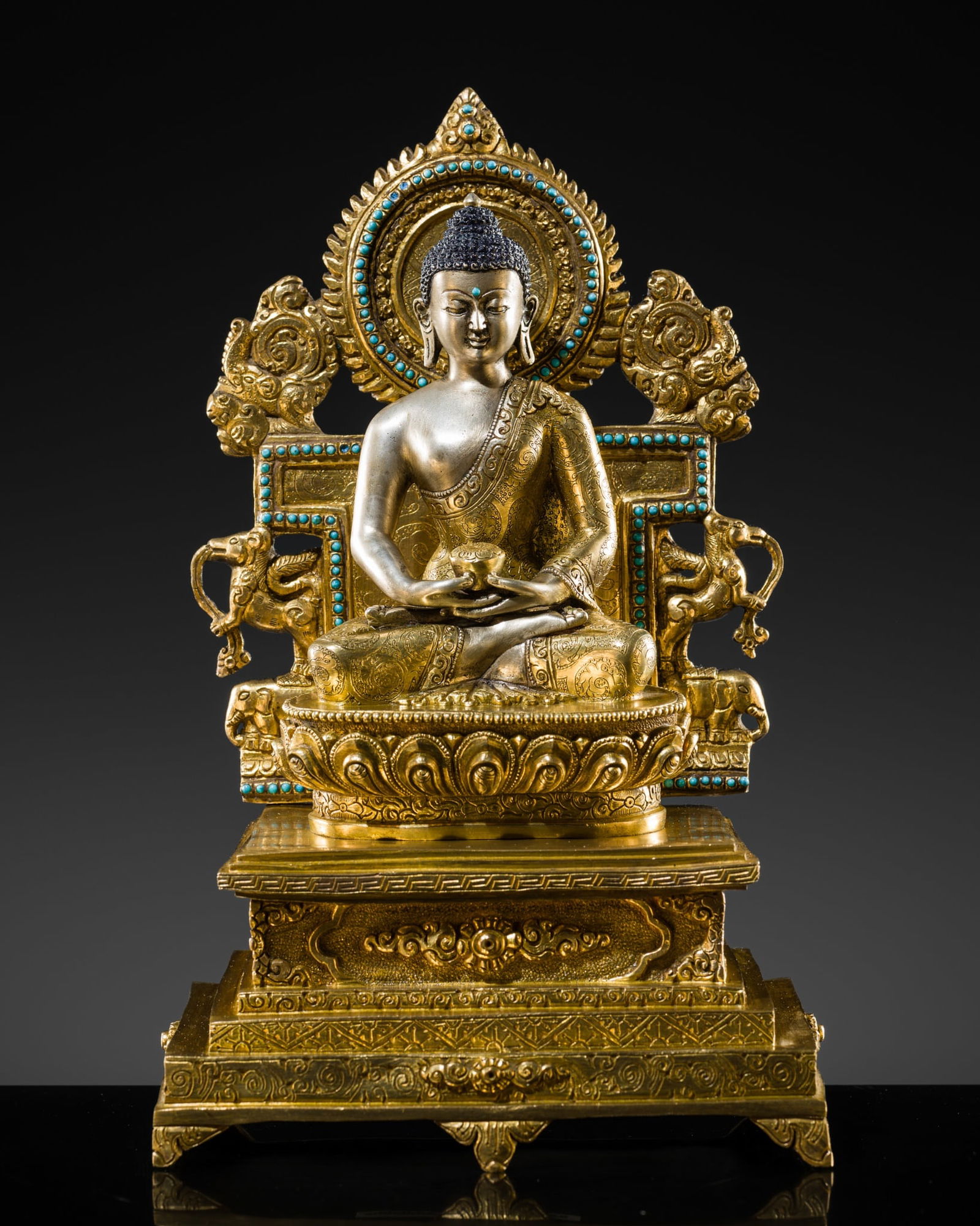 A TURQUOISE-INLAID GILT AND SILVERED COPPER ALLOY FIGURE OF THE ENTHRONED BUDDHA (1 of 14)