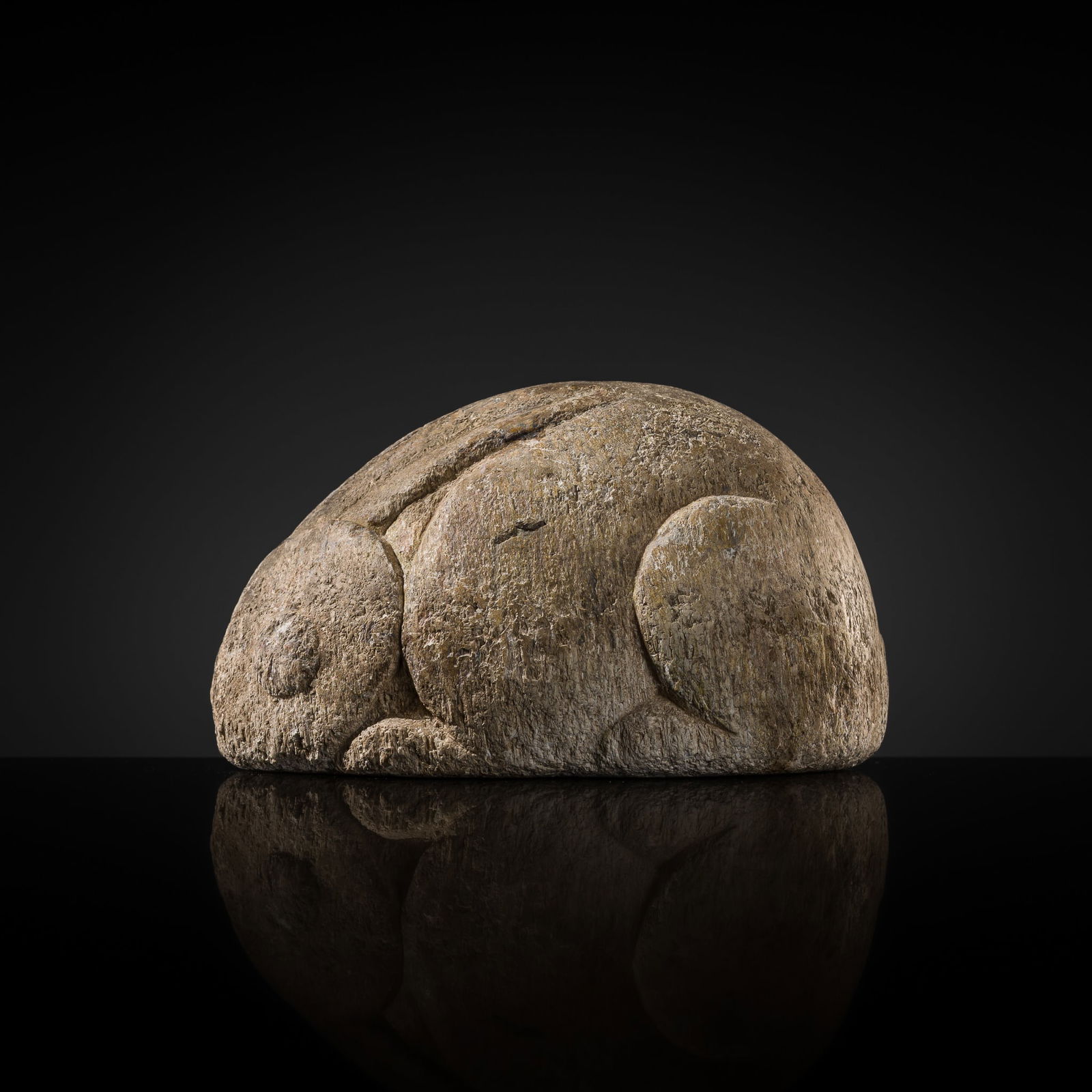 A WHITE MARBLE CARVING OF A CROUCHING RABBIT, TANG DYNASTY: A WHITE MARBLE CARVING OF A CROUCHING RABBIT, TANG DYNASTY China, 618-907. Skillfully carved in the round, the small animal depicted in a recumbent pose, its legs tucked neatly beneath the plump body,