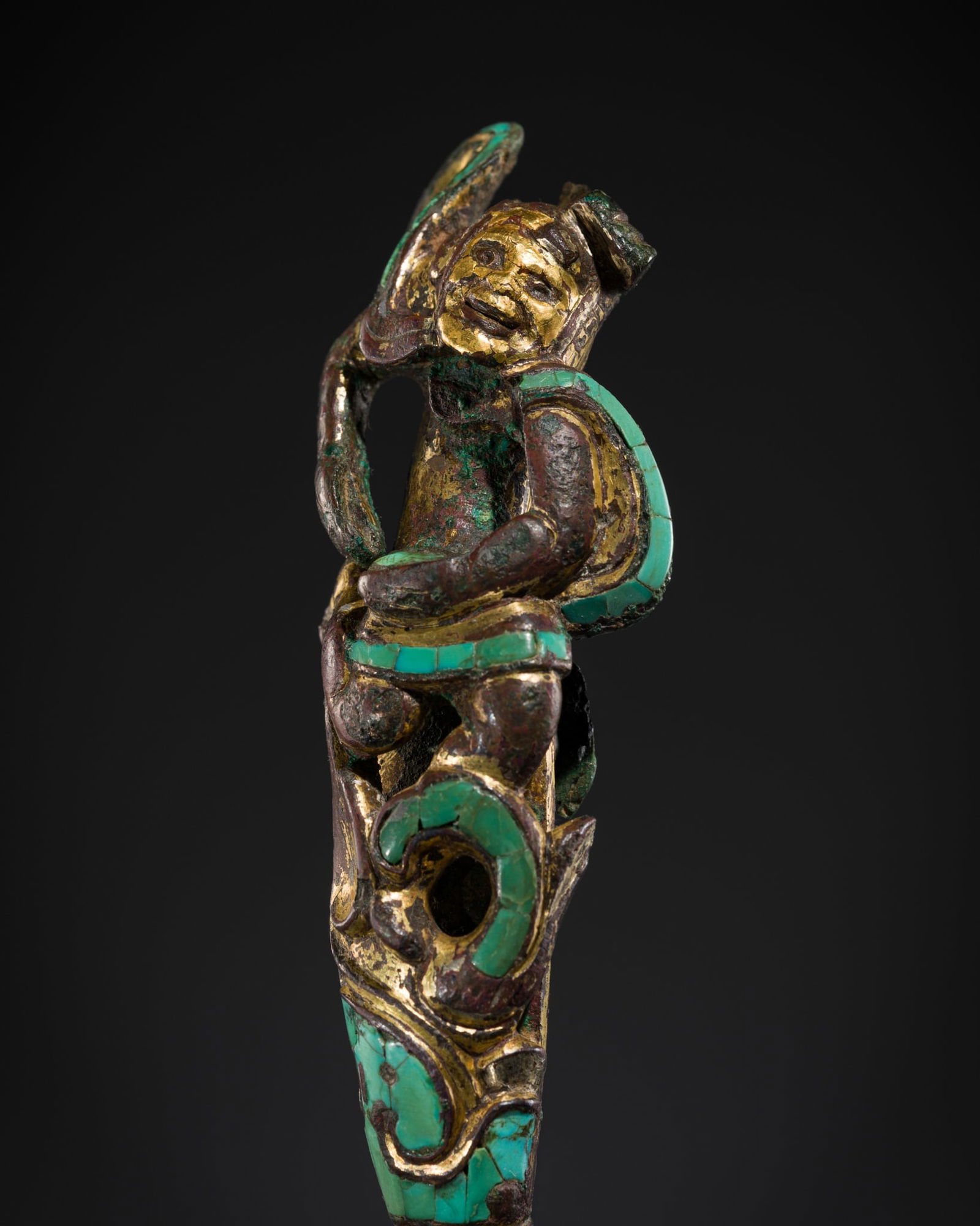A GOLD- AND TURQUOISE-INLAID BRONZE 'SLEEVE DANCER' BELT HOOK, HAN-WESTERN JIN DYNASTY: A GOLD- AND TURQUOISE-INLAID BRONZE 'SLEEVE DANCER' BELT HOOK, HAN-WESTERN JIN DYNASTY Expert's note:Although numerous pottery figures of dancers have been excavated from Han dynasty tomb assemblages,