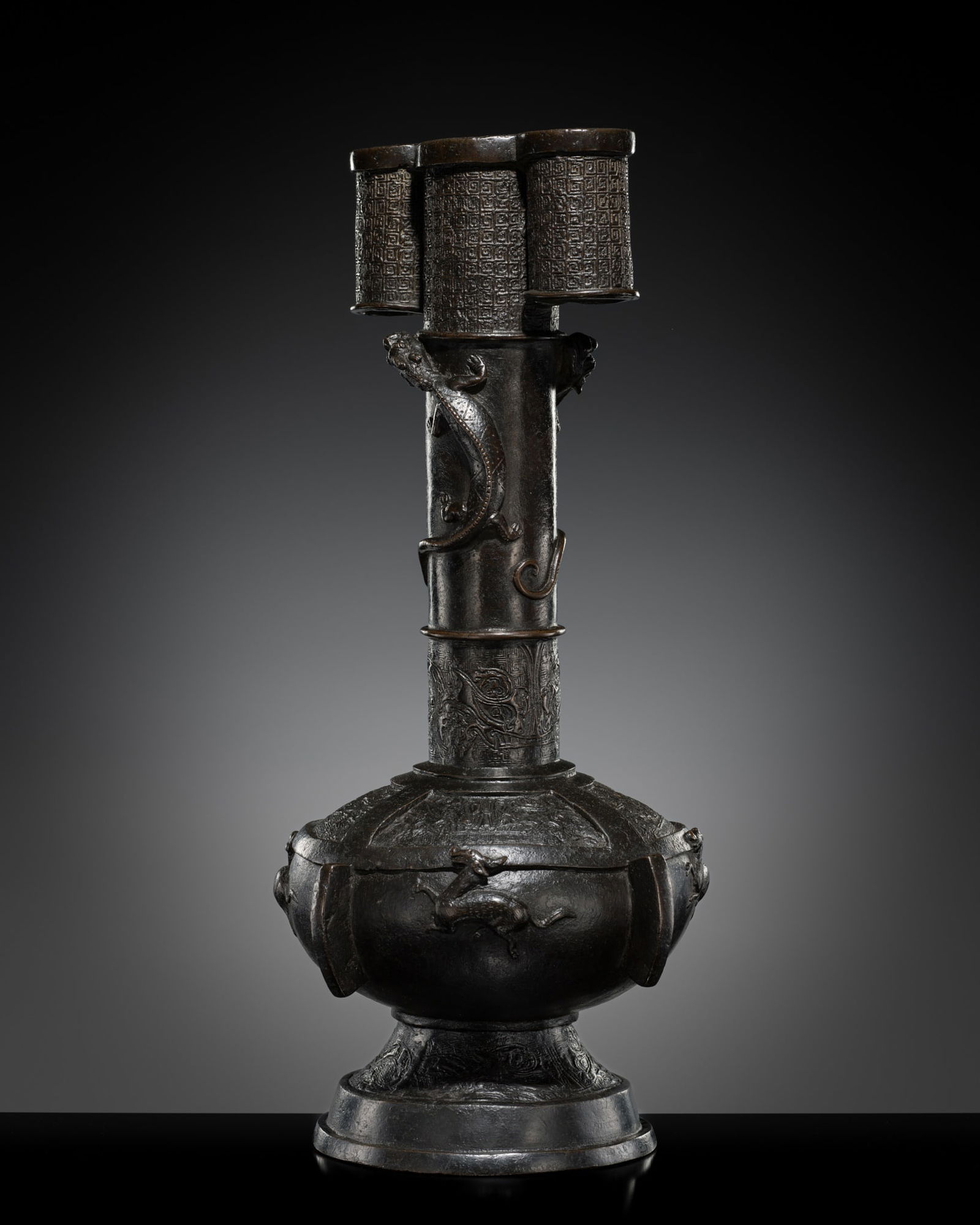 A LARGE BRONZE ARROW VASE, TOUHU, SONG TO YUAN DYNASTY: A LARGE BRONZE ARROW VASE, TOUHU, SONG TO YUAN DYNASTY China, 12th-13th century. Heavily cast, the globular body is supported on a stepped foot and rises to an elongated cylindrical neck flanked at th