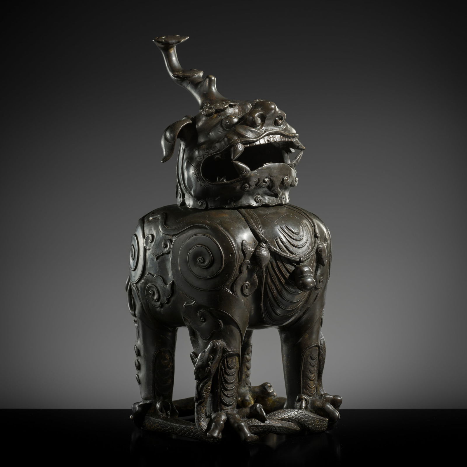 A LARGE AND MASSIVE 'LUDUAN' BRONZE CENSER AND COVER, LATE MING DYNASTY: A LARGE AND MASSIVE 'LUDUAN' BRONZE CENSER AND COVER, LATE MING DYNASTY China, 17th century. Heavily cast, the beast stands foursquare atop the coiled body of a serpent, its scales minutely incised in