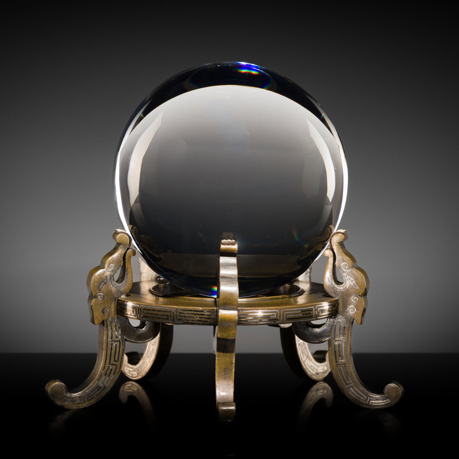 A BARIUM LEAD GLASS SPHERE WITH A SILVER-INLAID 'FIVE CHILONG' BRONZE STAND, 17TH-18TH CENTURY: A BARIUM LEAD GLASS SPHERE WITH A SILVER-INLAID 'FIVE CHILONG' BRONZE STAND, 17TH-18TH CENTURY Expert's note:The earliest type of glass manufactured in China was alkali and lime glass, which was soon
