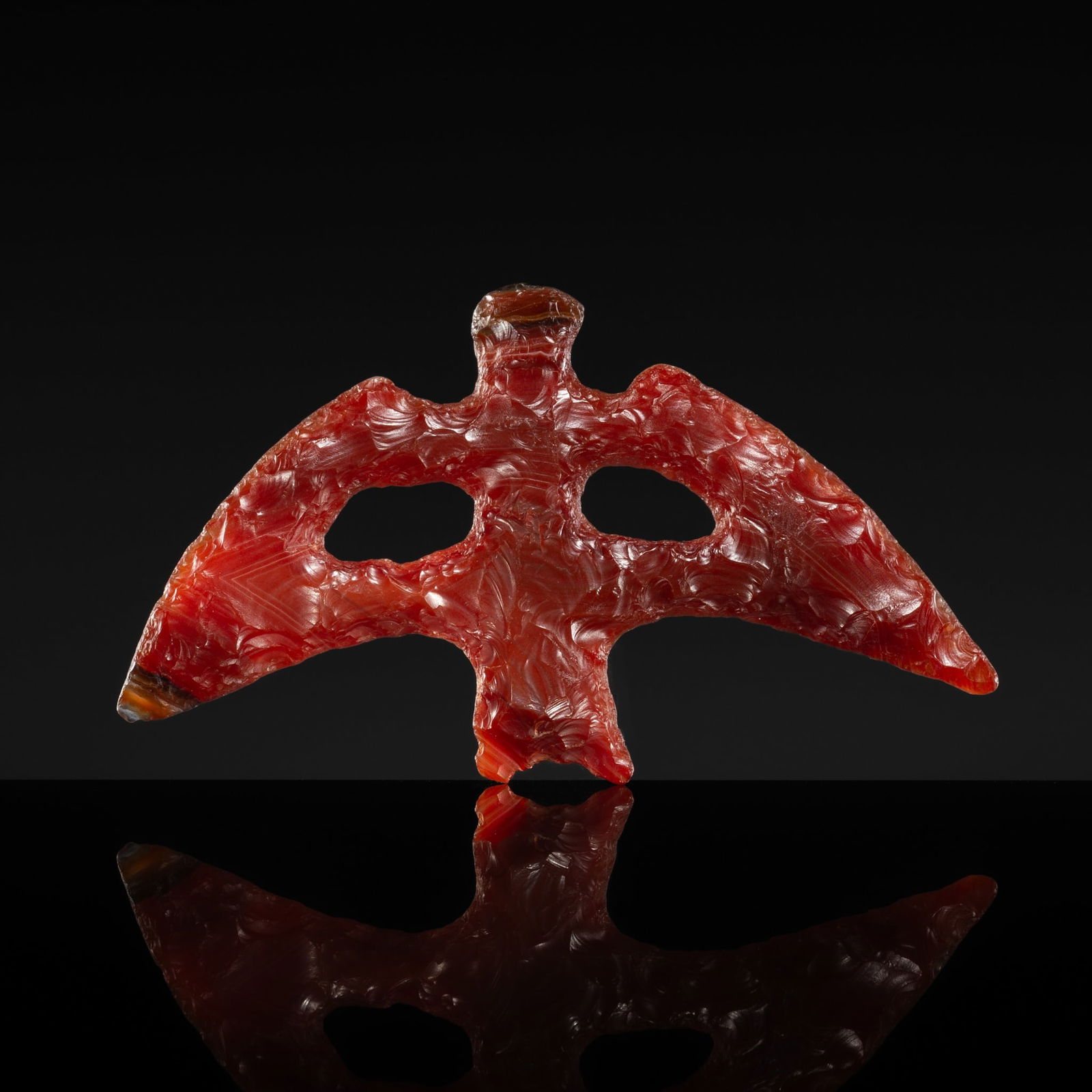 A CARNELIAN AGATE 'FLYING EAGLE' PENDANT, NEOLITHIC PERIOD, HONGSHAN CULTURE: A CARNELIAN AGATE 'FLYING EAGLE' PENDANT, NEOLITHIC PERIOD, HONGSHAN CULTURE Expert authentication: Dr. Gu Fang has examined the present lot and confirms its authenticity and the dating above, noting