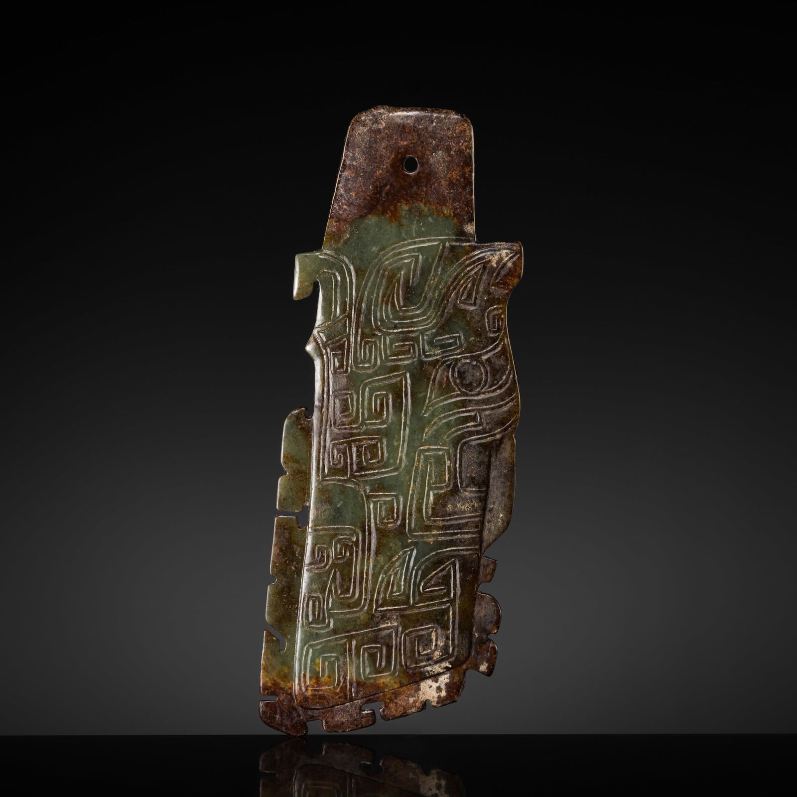 A GREEN AND RUSSET JADE 'TIGER' PENDANT, LATE SHANG-EARLY WESTERN ZHOU DYNASTY (1 of 12)