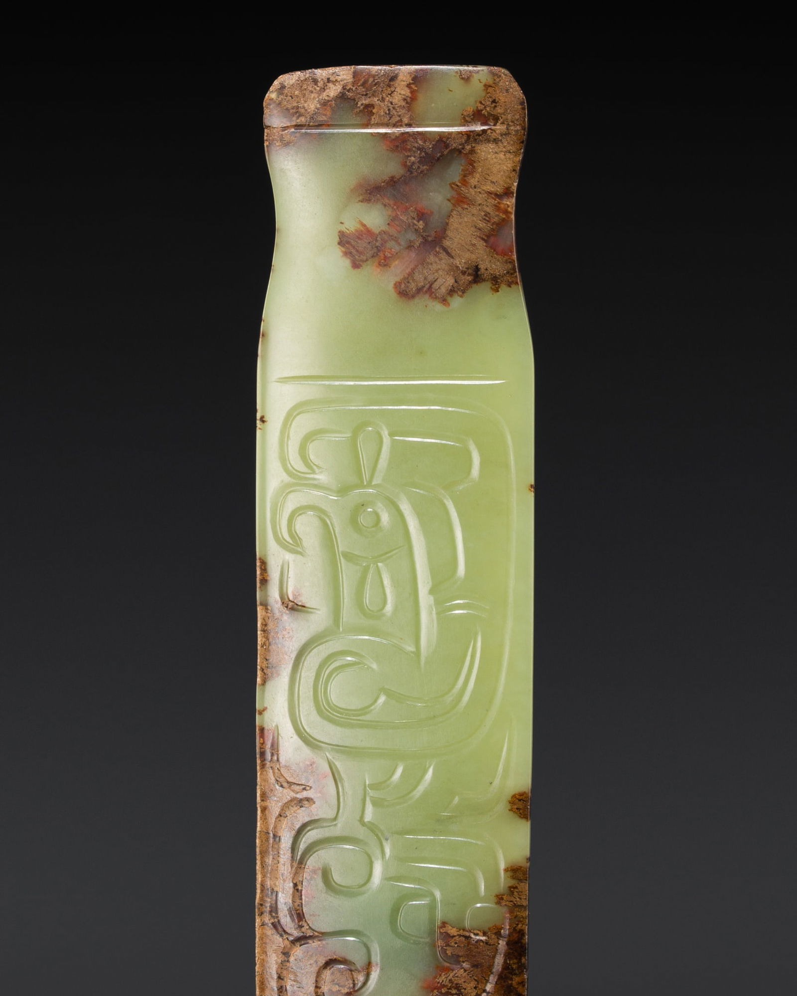 A GREEN AND RUSSET JADE 'PHOENIX AND DRAGON' PENDANT, WESTERN ZHOU DYNASTY (1 of 17)