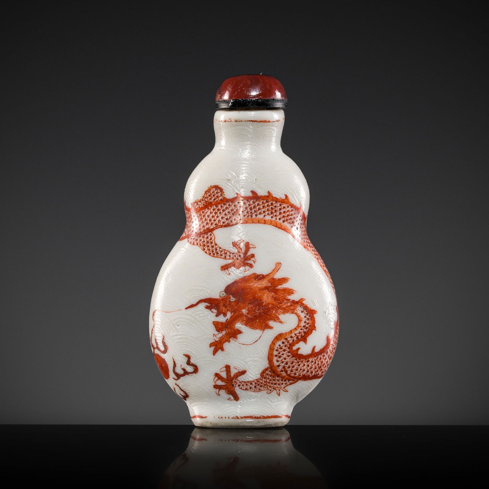 AN IRON-RED 'DRAGON' SGRAFFIATO SNUFF BOTTLE, DAOGUANG PERIOD (1 of 13)