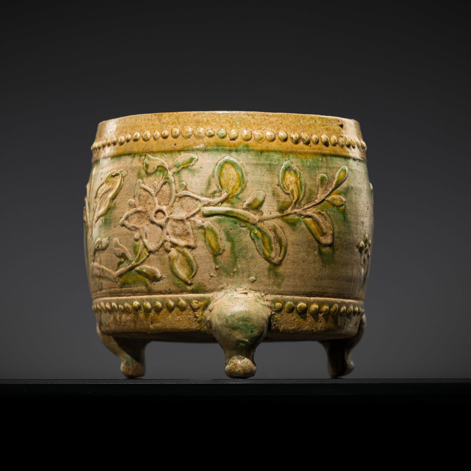 A SANCAI-GLAZED DRUM-FORM 'PEONY' TRIPOD CENSER, LIAO DYNASTY (916-1125) (1 of 14)