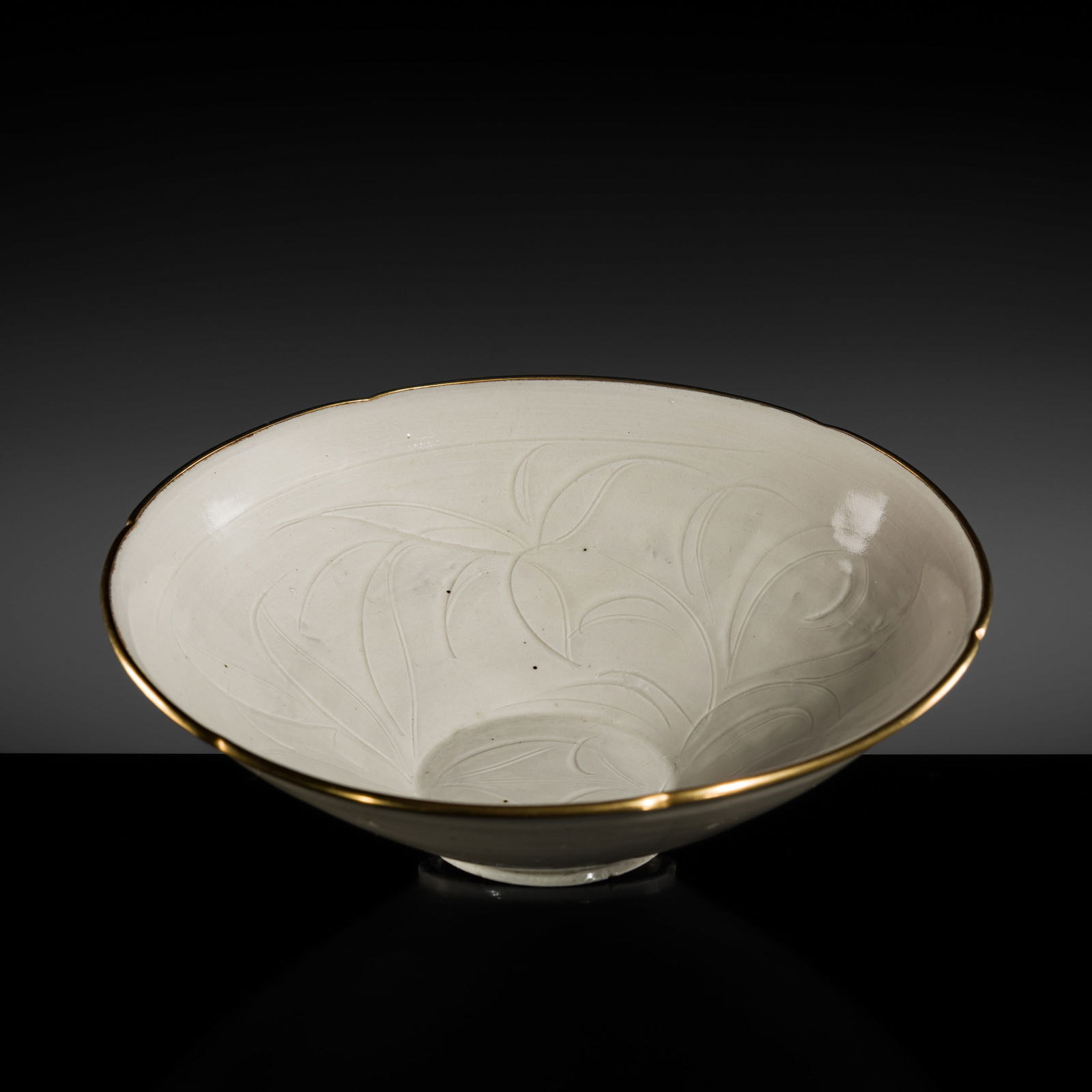 A CARVED DINGYAO 'DAY LILY' BOWL, NORTHERN SONG DYNASTY, 12TH CENTURY: A CARVED DINGYAO 'DAY LILY' BOWL, NORTHERN SONG DYNASTY, 12TH CENTURY Expert Authentication: Takatoshi Misugi examined the present lot and confirmed its authenticity and the dating above. A copy of Mi