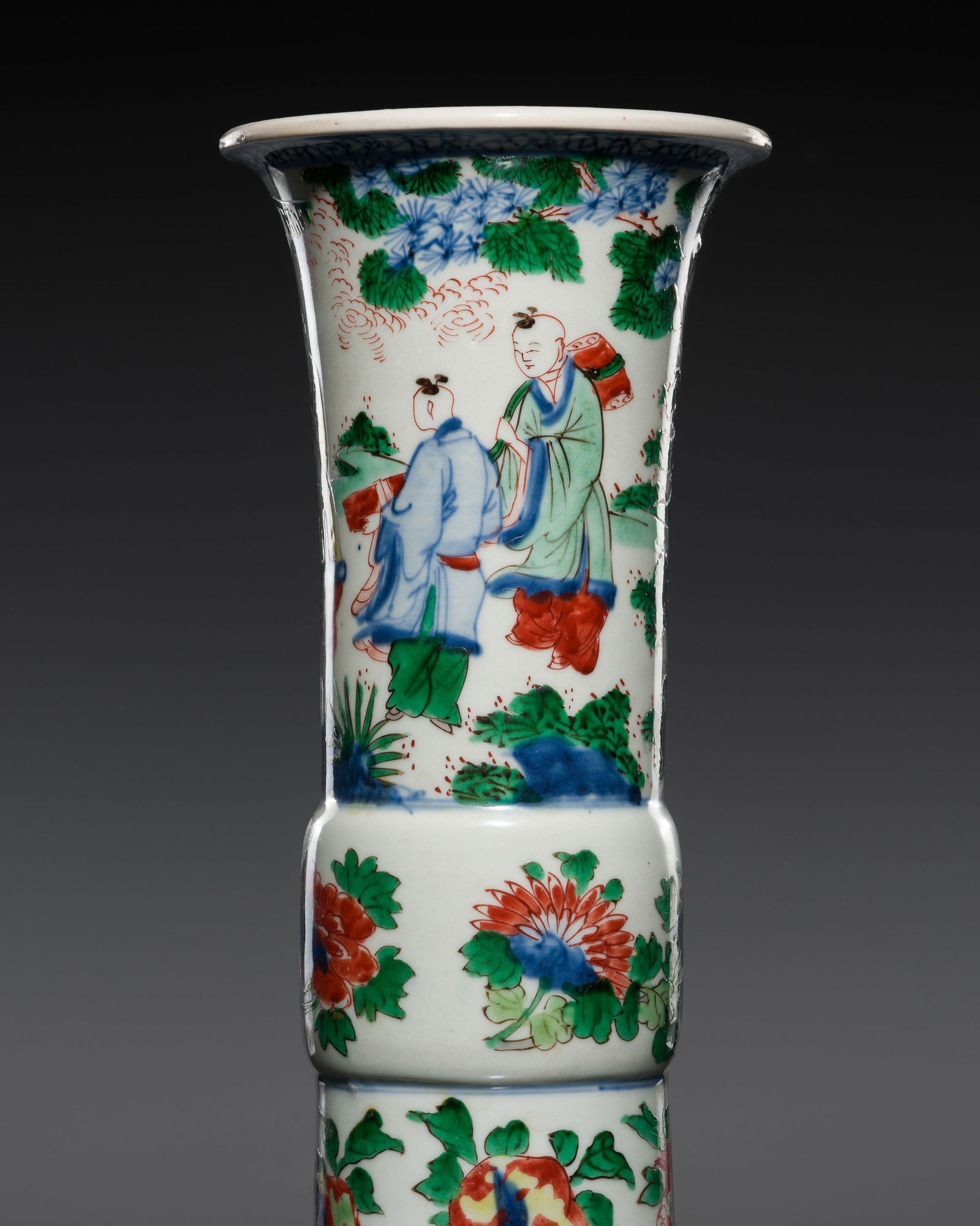 A WUCAI 'LU XING' BEAKER VASE, GU, TRANSITIONAL PERIOD: A WUCAI 'LU XING' BEAKER VASE, GU, TRANSITIONAL PERIOD China, mid-17th century. The slightly spreading foot rising to a bulbous mid-section and a tall cylindrical neck with a thick everted lip. Finely