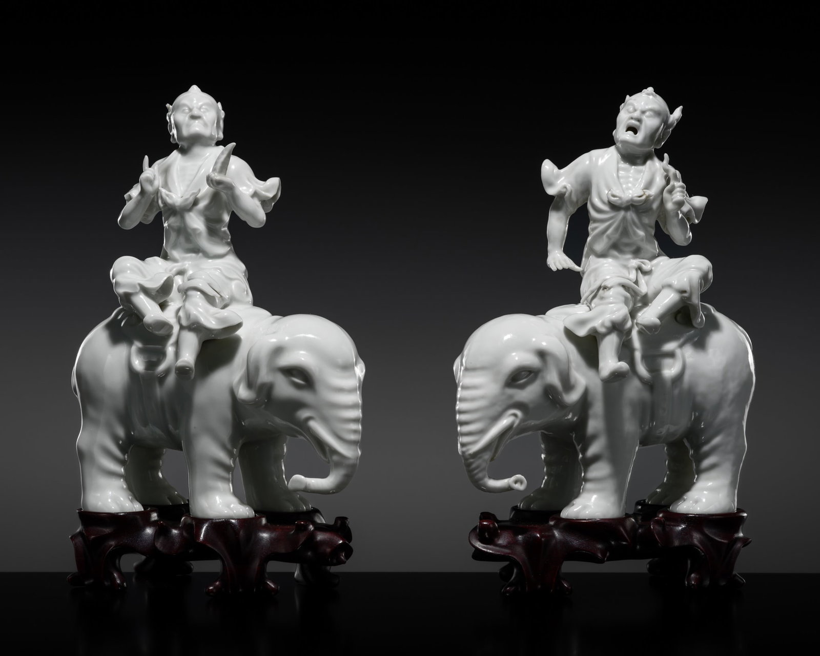 A PAIR OF DEHUA FIGURES OF FOREIGN TRIBUTE BEARERS RIDING ELEPHANTS, QING DYNASTY: A PAIR OF DEHUA FIGURES OF FOREIGN TRIBUTE BEARERS RIDING ELEPHANTS, QING DYNASTY China, Fujian Province, 18th to early 19th century. Each finely potted and covered overall in a glaze of cool white to