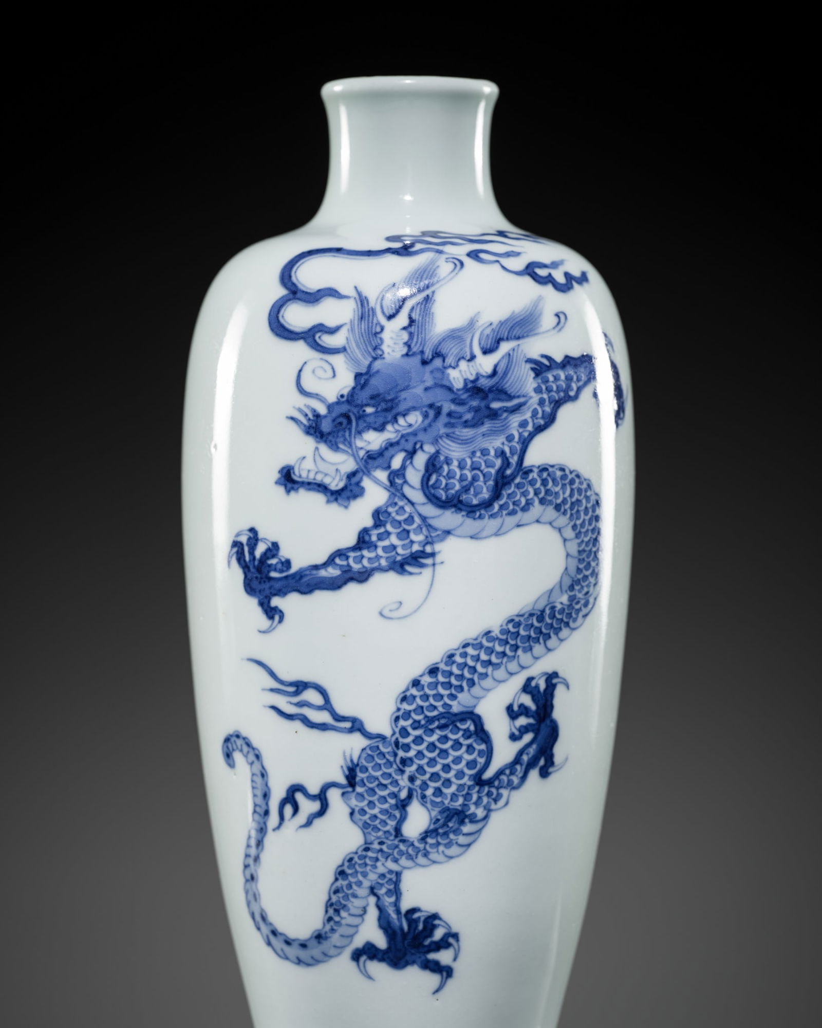 A BLUE AND WHITE 'DRAGON' VASE, QING DYNASTY, 18TH CENTURY: A BLUE AND WHITE 'DRAGON' VASE, QING DYNASTY, 18TH CENTURY China. Sturdily yet elegantly potted, the slender ovoid body rising from a short foot with a concave base to a waisted neck with a lipped rim