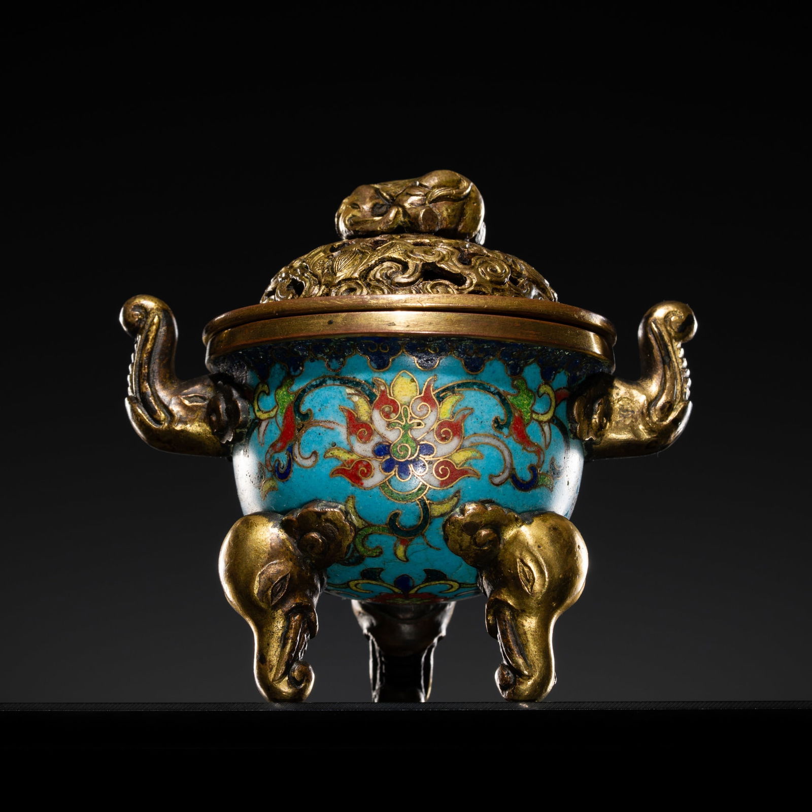 A SMALL GILT-BRONZE CLOISONNÉ ENAMEL 'ELEPHANT' CENSER, QIANLONG PERIOD: A SMALL GILT-BRONZE CLOISONNÉ ENAMEL 'ELEPHANT' CENSER, QIANLONG PERIOD China, 1736-1795. The body is decorated with scrolling lotus reserved against a turquoise ground, raised on three gilt-bron