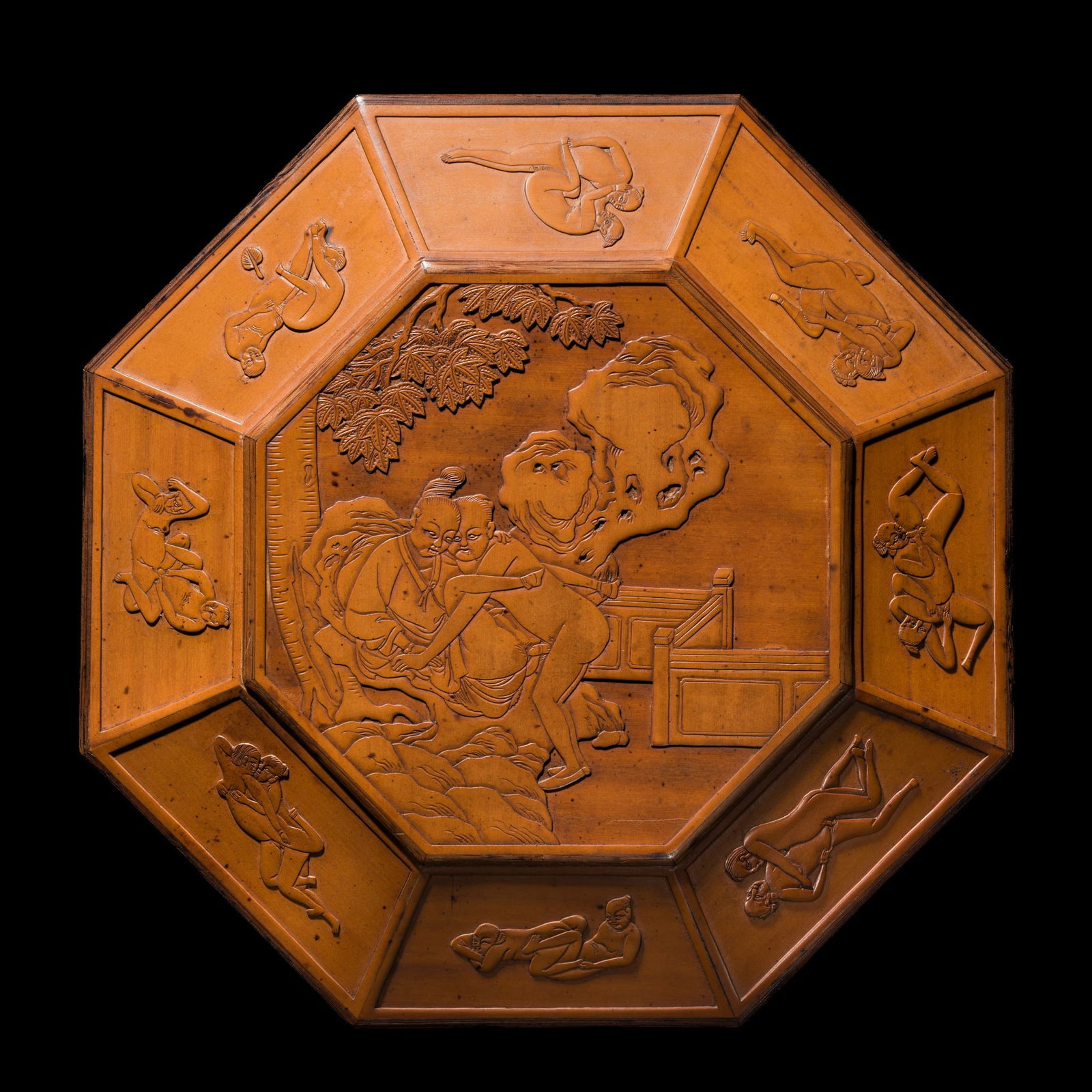 AN 'EROTIC' BAMBOO VENEER BOX AND COVER, ZHUHUANG, QING DYNASTY: AN 'EROTIC' BAMBOO VENEER BOX AND COVER, ZHUHUANG, QING DYNASTY China, 1644-1912. Of octagonal form, the flush-fitting cover finely carved with a couple engaged in amorous pursuits on a scholar's rock