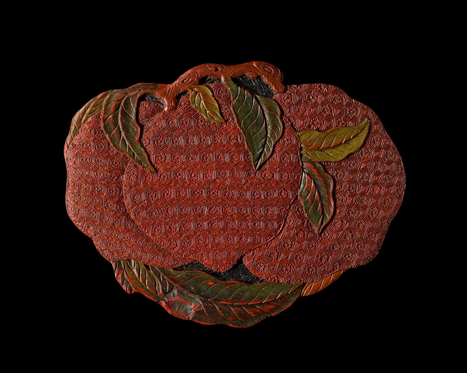 A RARE FOUR-COLOR LACQUER 'THREE PEACHES' BOX AND COVER, QIANLONG PERIOD: A RARE FOUR-COLOR LACQUER 'THREE PEACHES' BOX AND COVER, QIANLONG PERIOD China, 1736-1795. Finely carved at the top with a brown gnarled stem issuing leaves in two shades of green as well as three rip