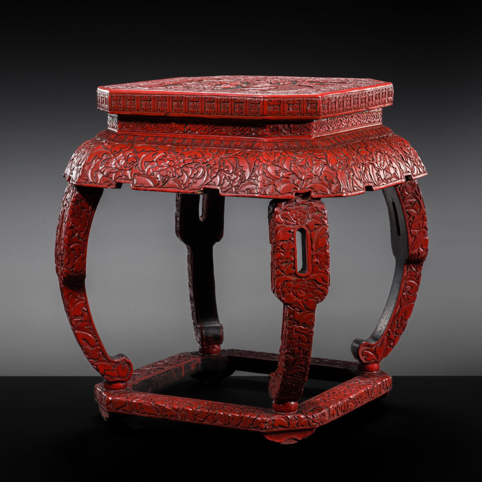A TWO-COLOR CINNABAR LACQUER INCENSE STAND, QING DYNASTY: A TWO-COLOR CINNABAR LACQUER INCENSE STAND, QING DYNASTY China, 1644-1912. Of square form with canted corners, raised on four elegantly curved and pierced legs terminating in hoof feet and supported o