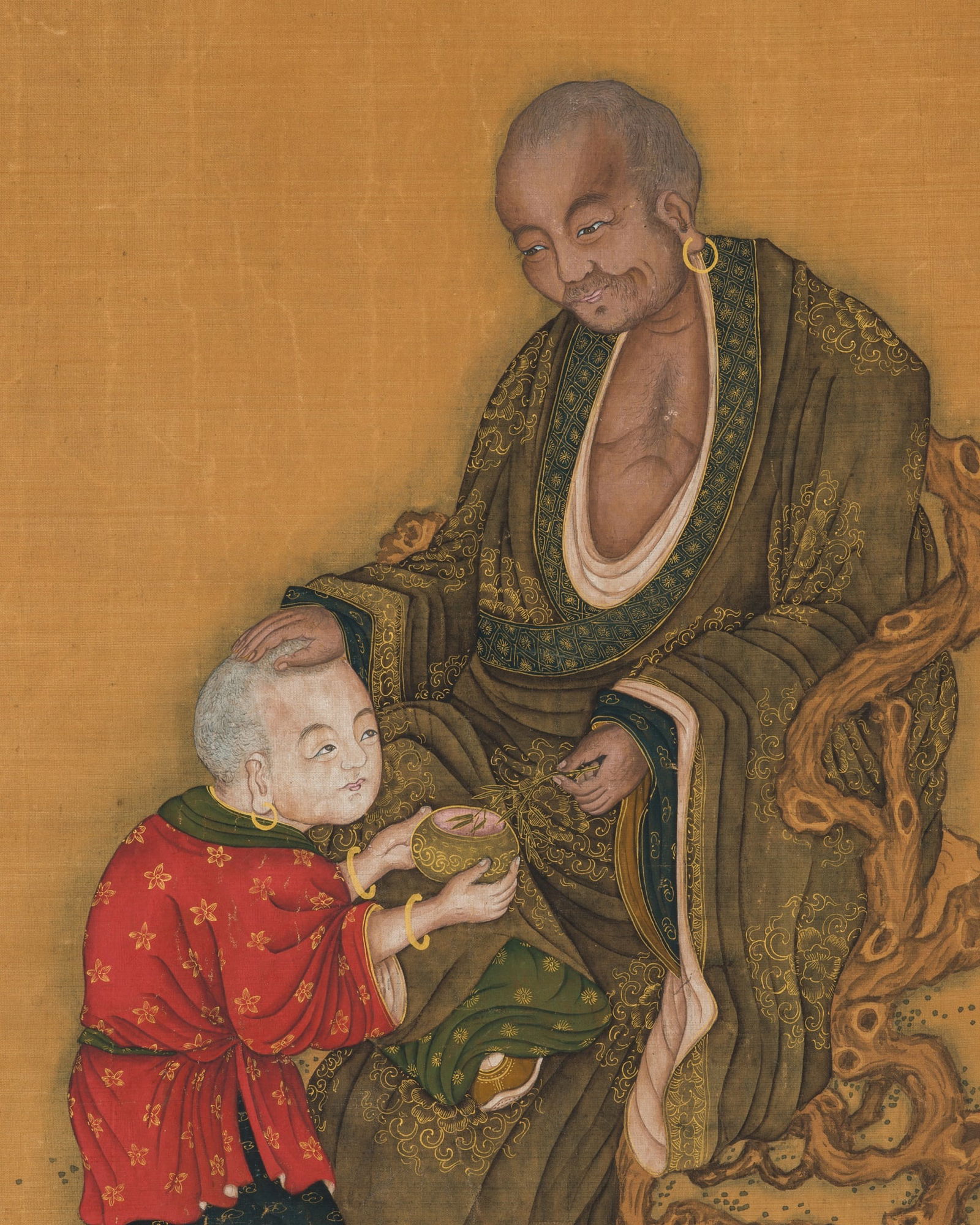 A LUOHAN BLESSING A YOUNG BOY', 17TH-18TH CENTURY: 'A LUOHAN BLESSING A YOUNG BOY', 17TH-18TH CENTURY China. Gilt, ink, watercolors, and gouache on silk. The painting likely represents the Jubo Luohan (Arhat raising an alms bowl) who is depicted seate