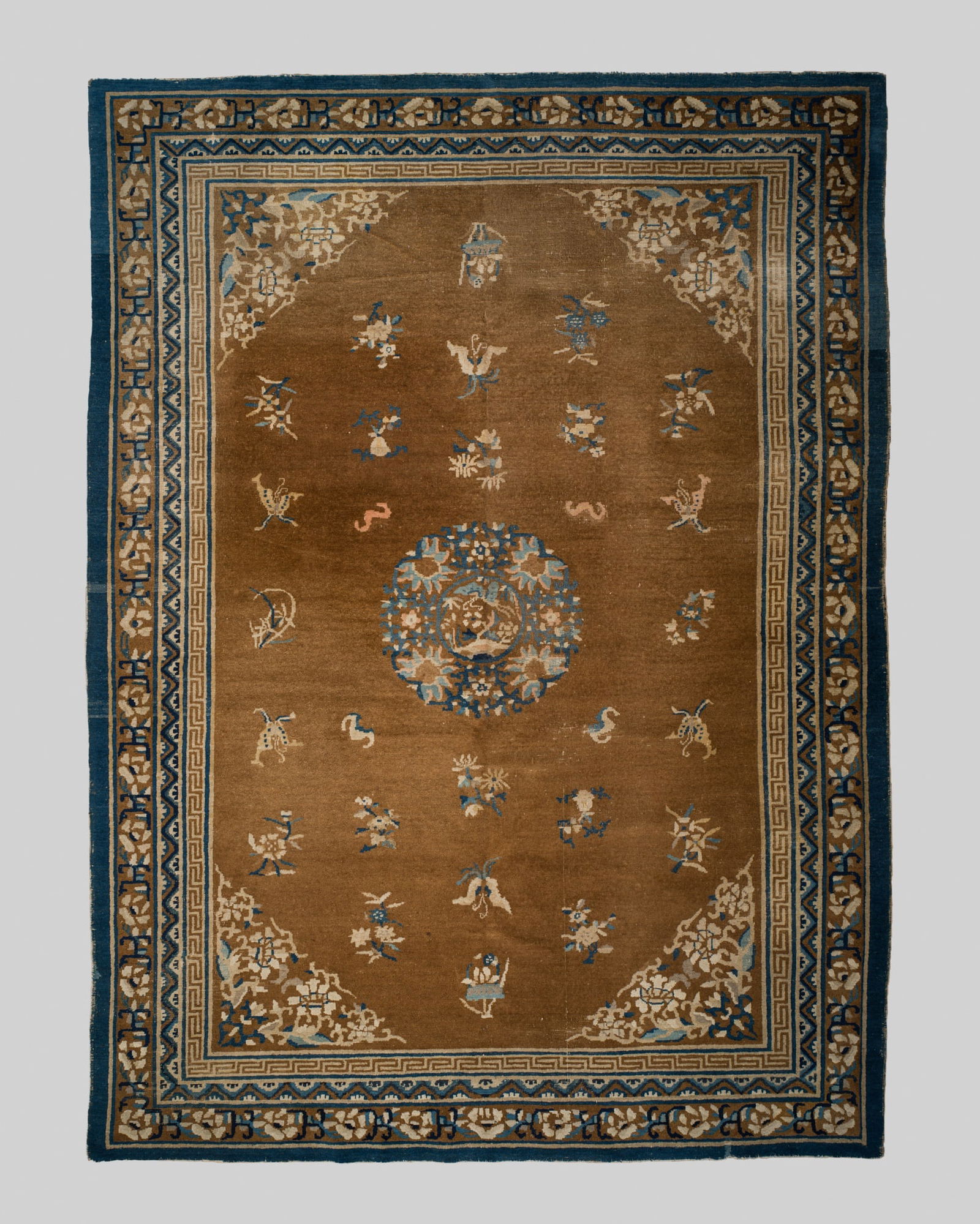 A FINE AND WELL-PRESERVED NINGXIA WOOL CARPET, EARLY 19TH CENTURY: A FINE AND WELL-PRESERVED NINGXIA WOOL CARPET, EARLY 19TH CENTURY China. Finely woven in shades of caramel-brown, cream, and blue, featuring a central medallion enclosing a butterfly amid flowers, sur